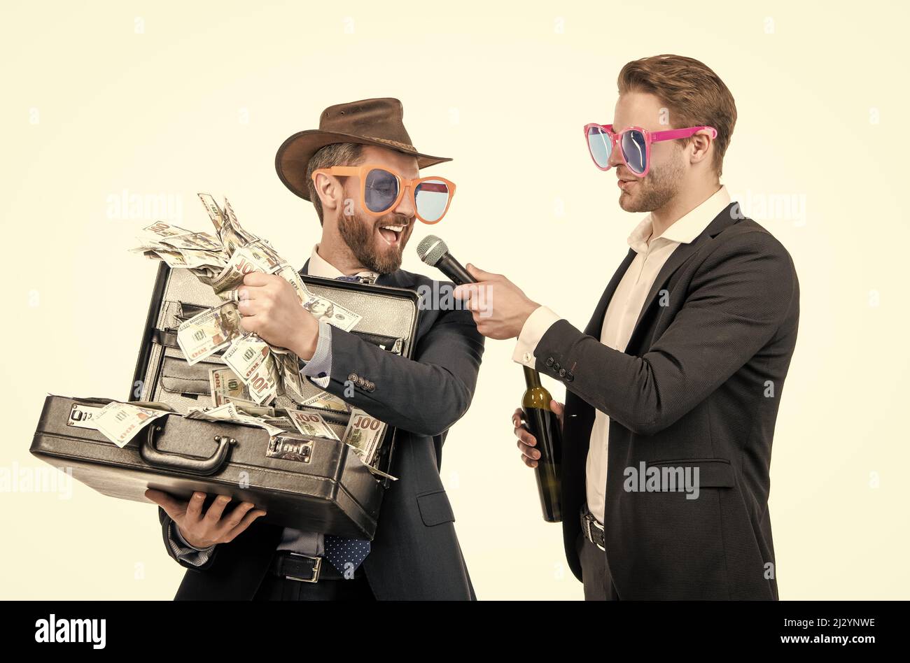 Newsman interview happy winner. Winning man hold money suitcase. Big money Stock Photo