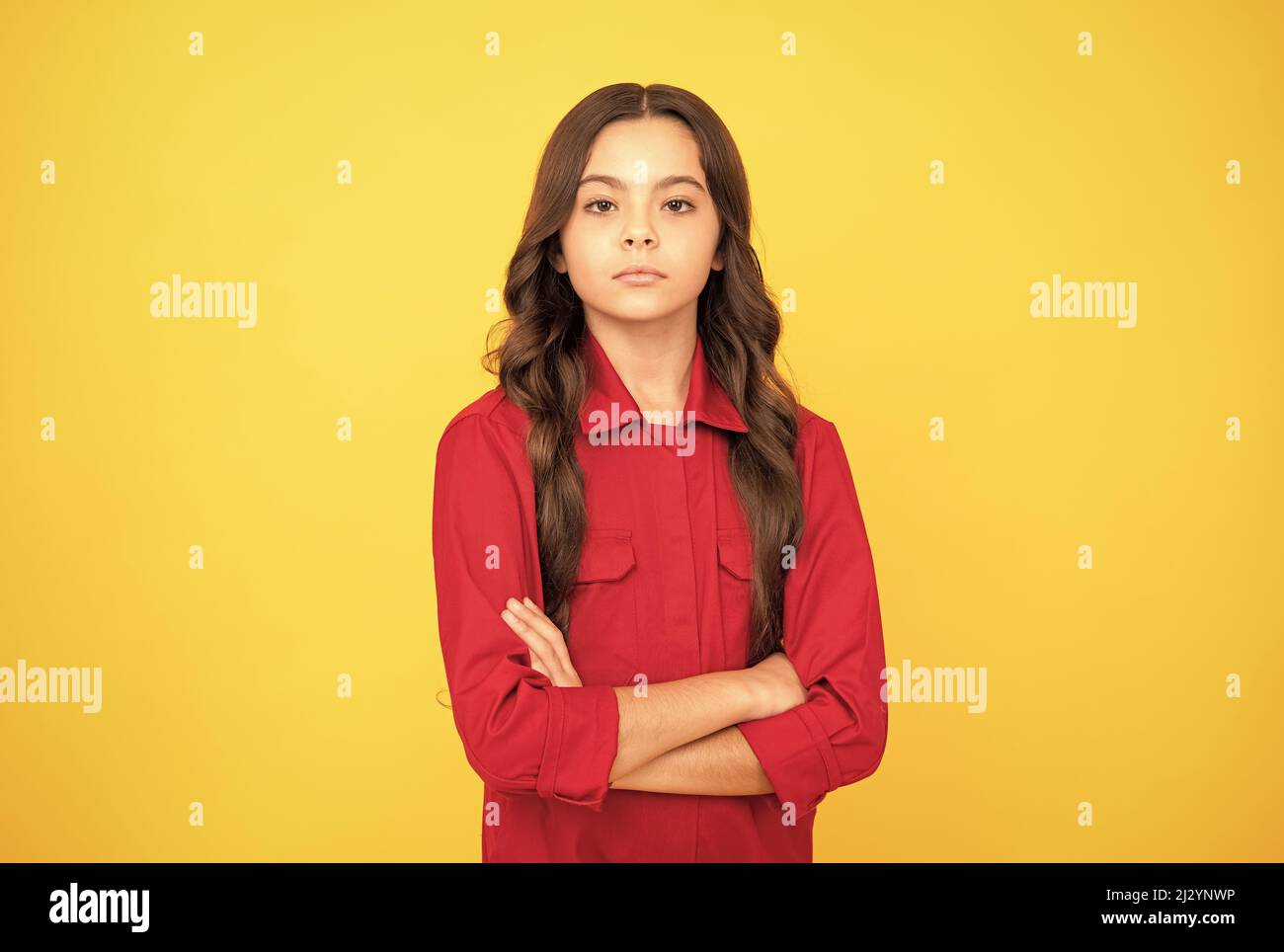 confident and serious teenager girl in red shirt crossed hands, confidence Stock Photo