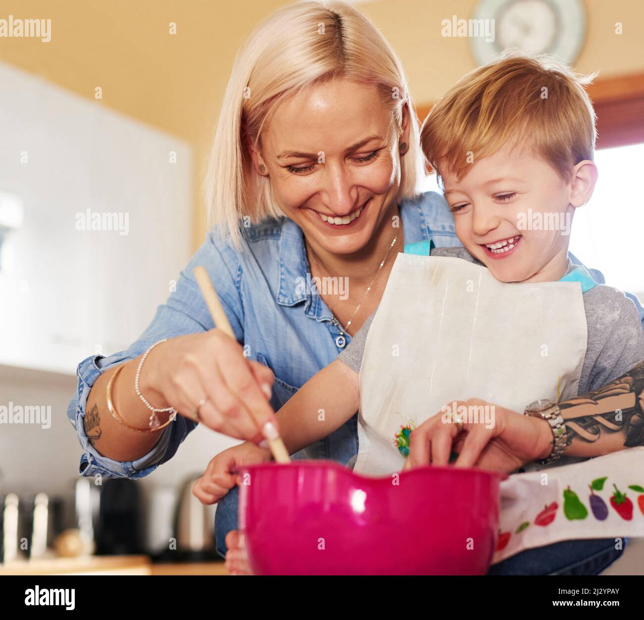 The secret ingredient is adding some fun into the mix. Cropped shot of a mother and son baking together at home. Stock Photo