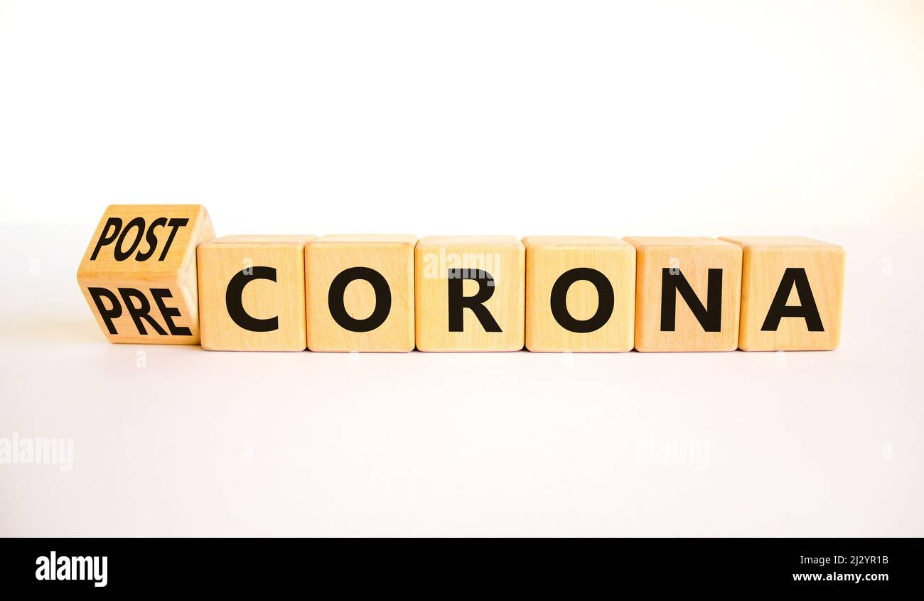 Covid-19 post or pre corona symbol. Turned wooden cubes and changed concept words Pre corona to Post corona. Beautiful white background. Covid-19 pand Stock Photo