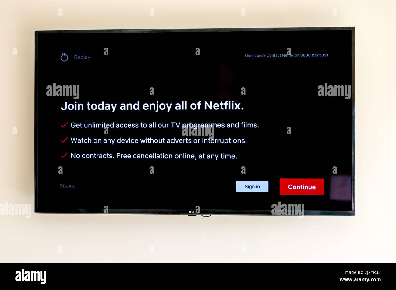 Netflix sign up screen on TV screen wall mounted Stock Photo