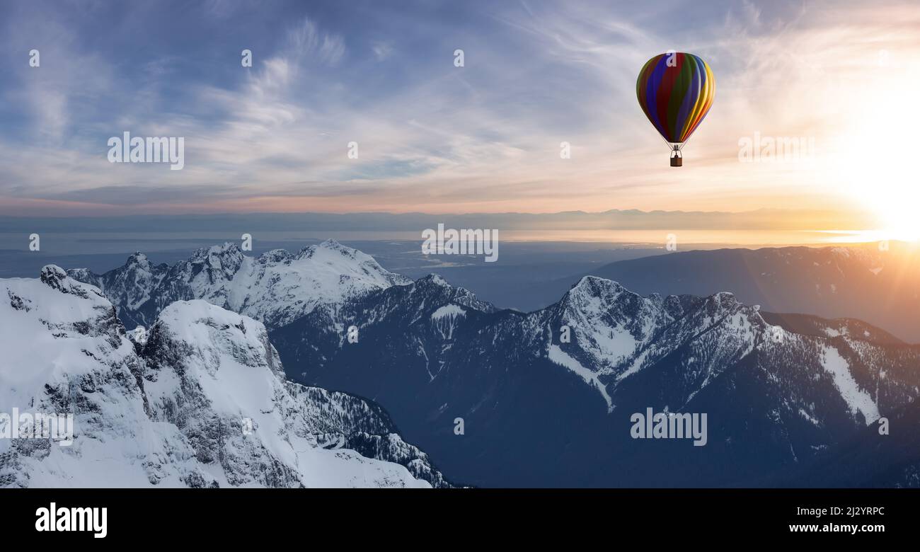 Dramatic Mountain Landscape covered in clouds and Hot Air Balloon ...