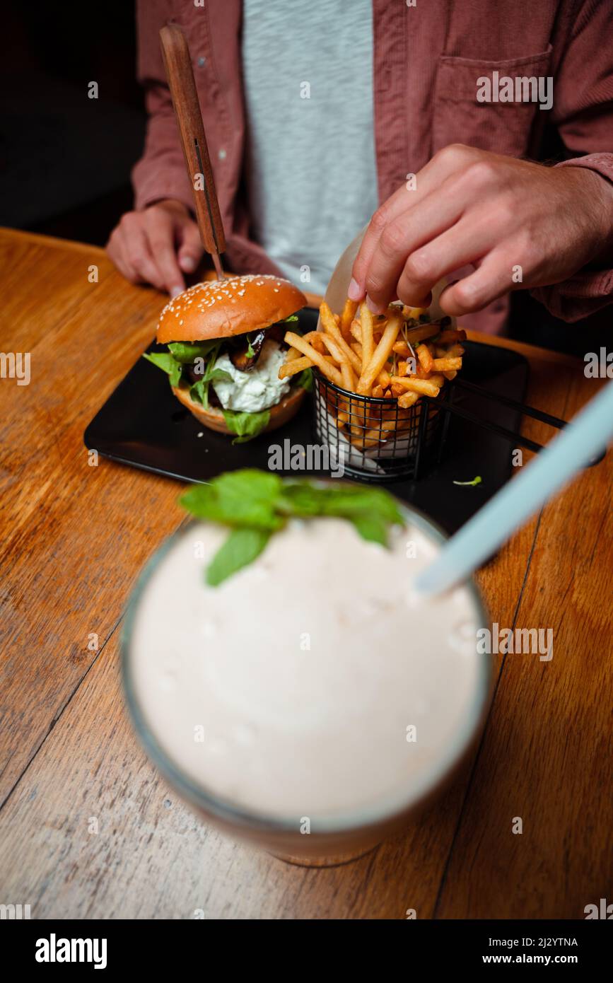 friends eating buger and milkshake at the restaraunt Stock Photo