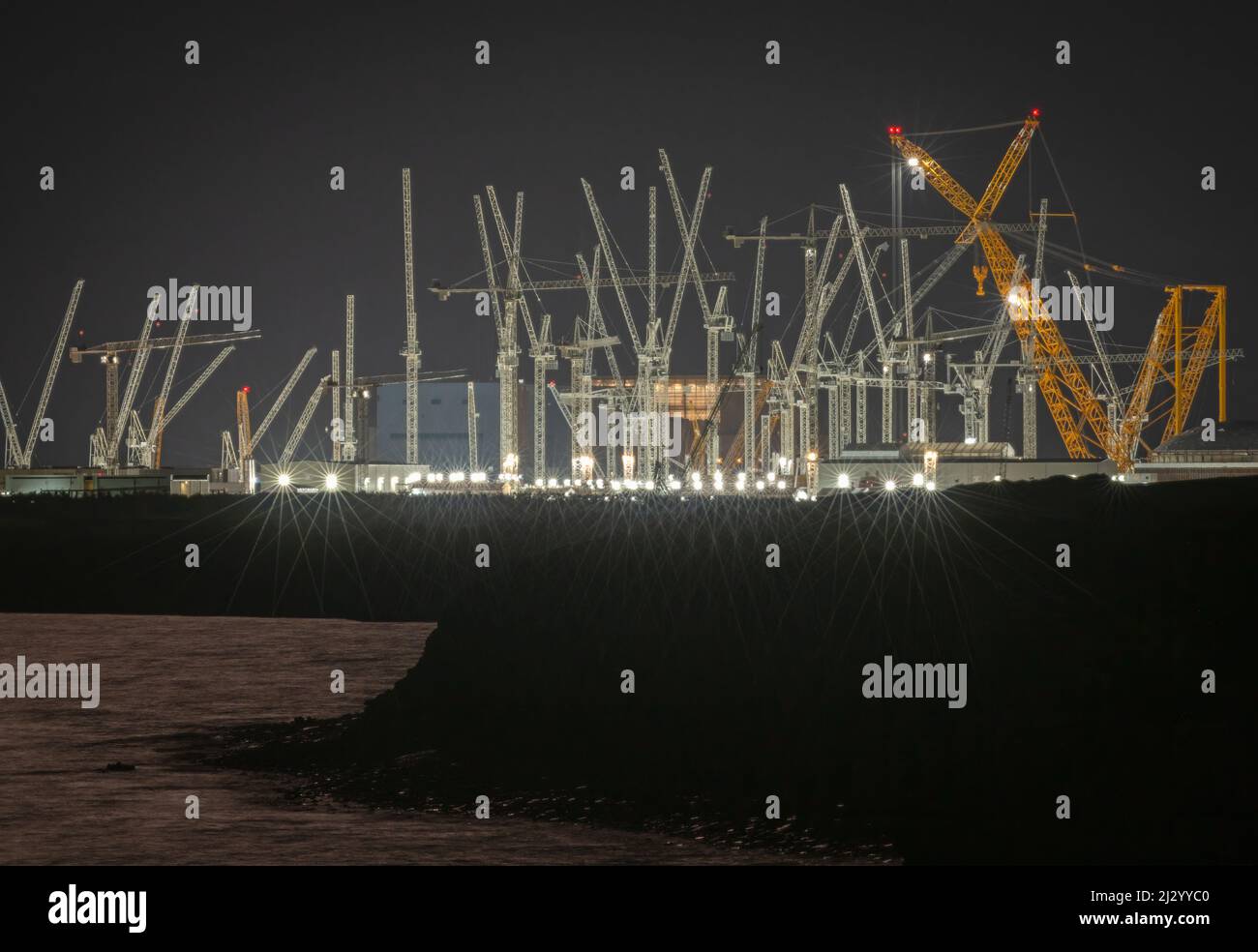 Night time view of the EDF Nuclear  Power Station construction site at Hinkley Point on the Somerset Coast as seen from Lilstock, Somerset, England. Stock Photo