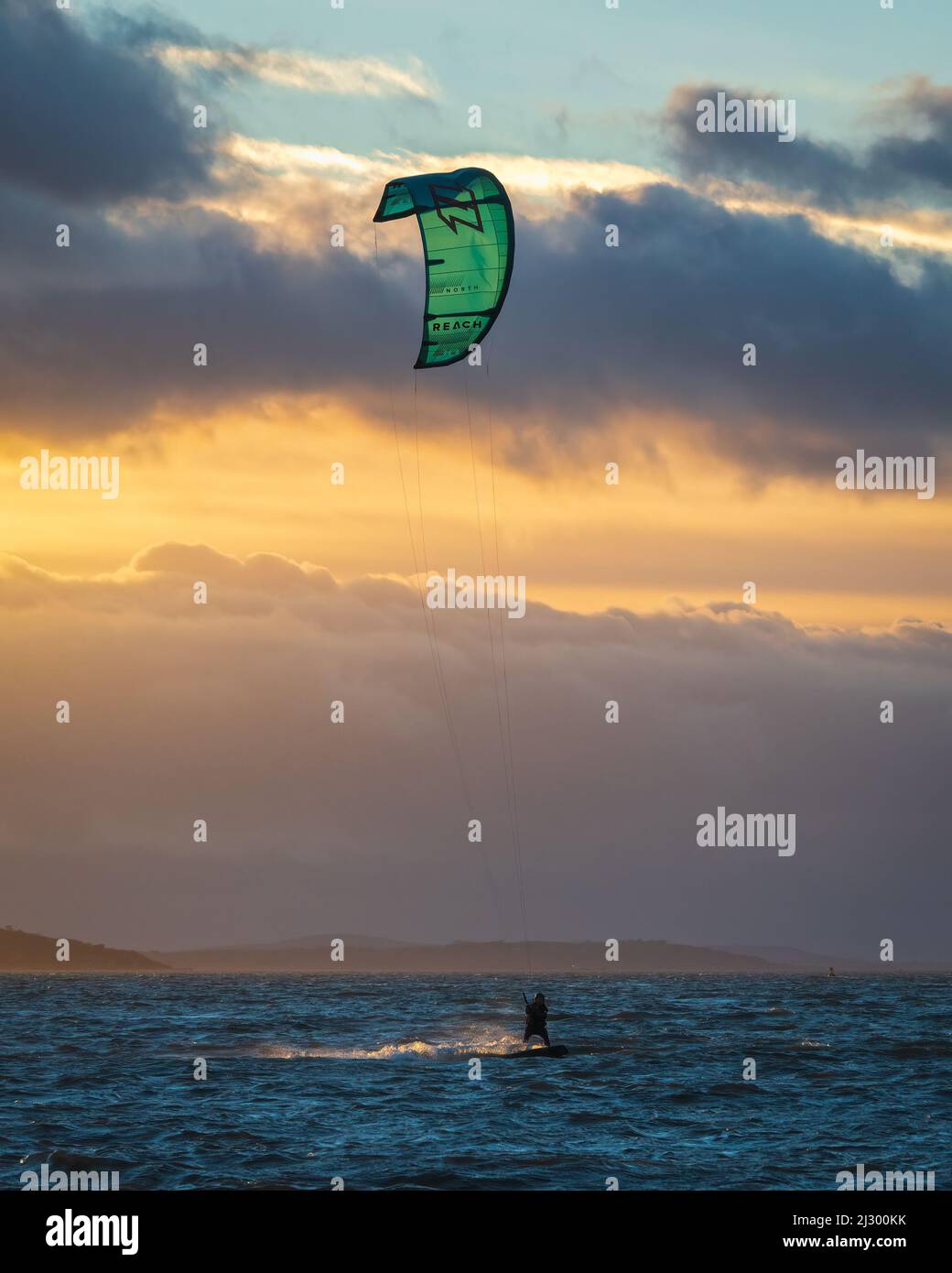Kite surfers making the most of a windy day on the Solent, just of the beach in Stokes Bay, Gosport, Hampshire, England, UK. Stock Photo