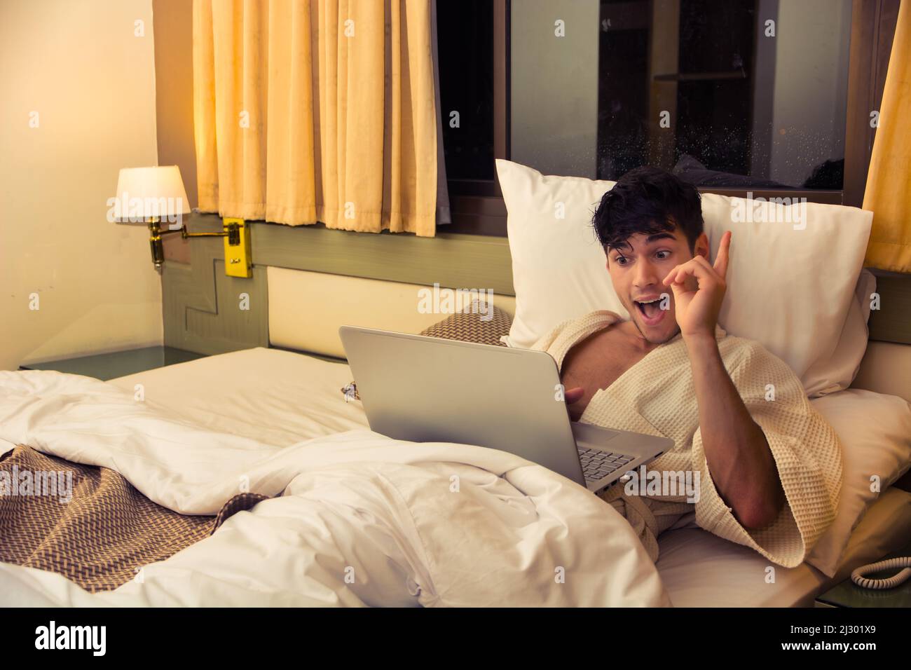 Young Male College or University Student Doing Homework, in Bedroom Stock Photo
