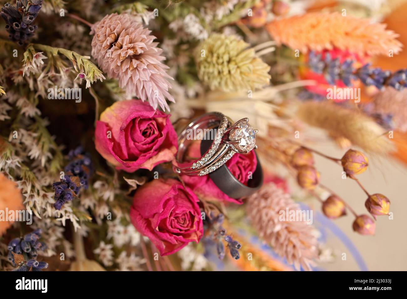 Diamond Wedding Ring with Wedding Band and Bouquet of Dried Wildflowers Stock Photo Alamy