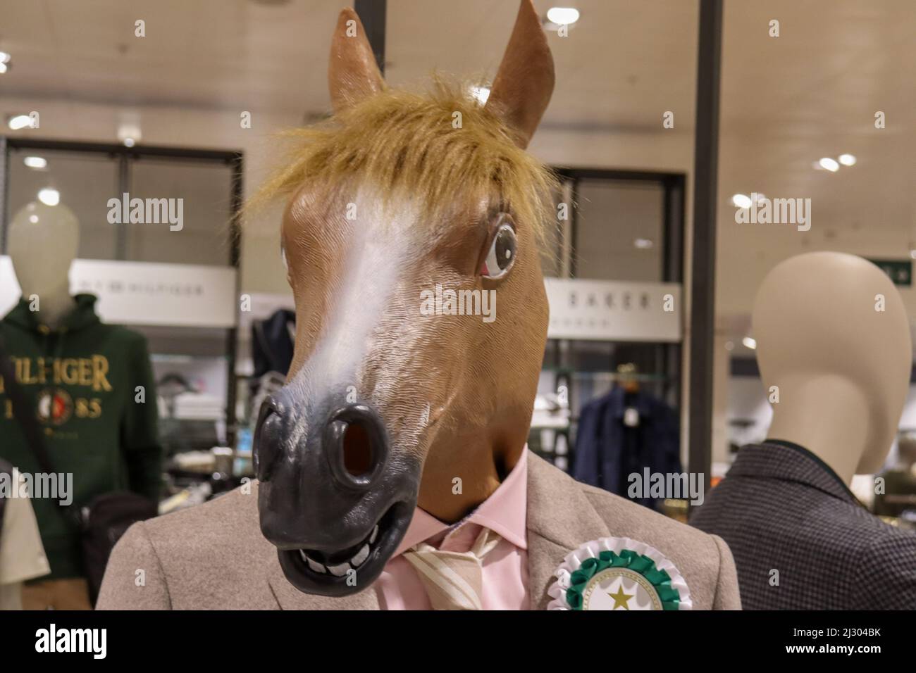 Horses head on a mannequin, in a menswear clothing department store Stock Photo