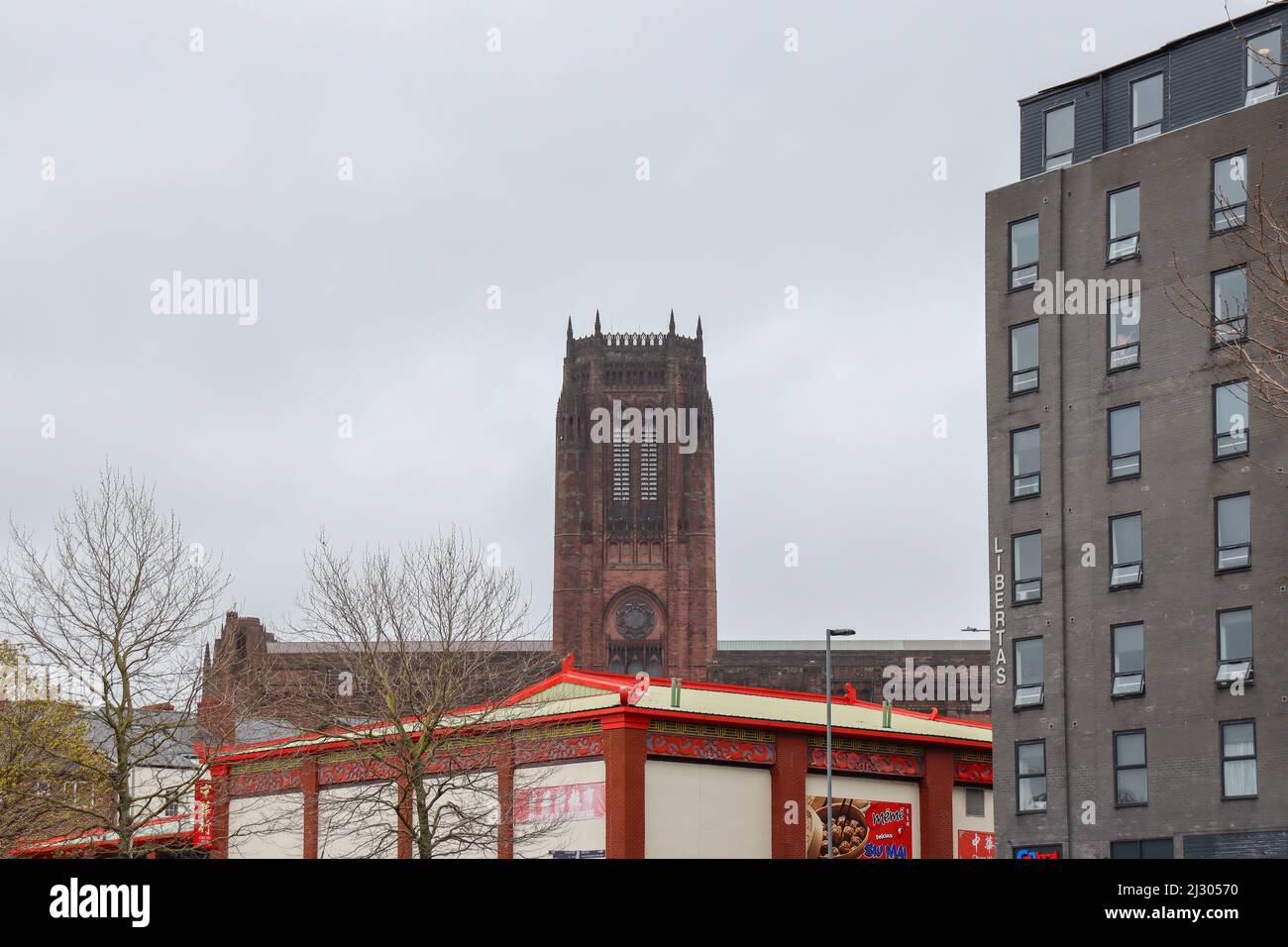Cathedral tower and Chinese Supermarket Stock Photo