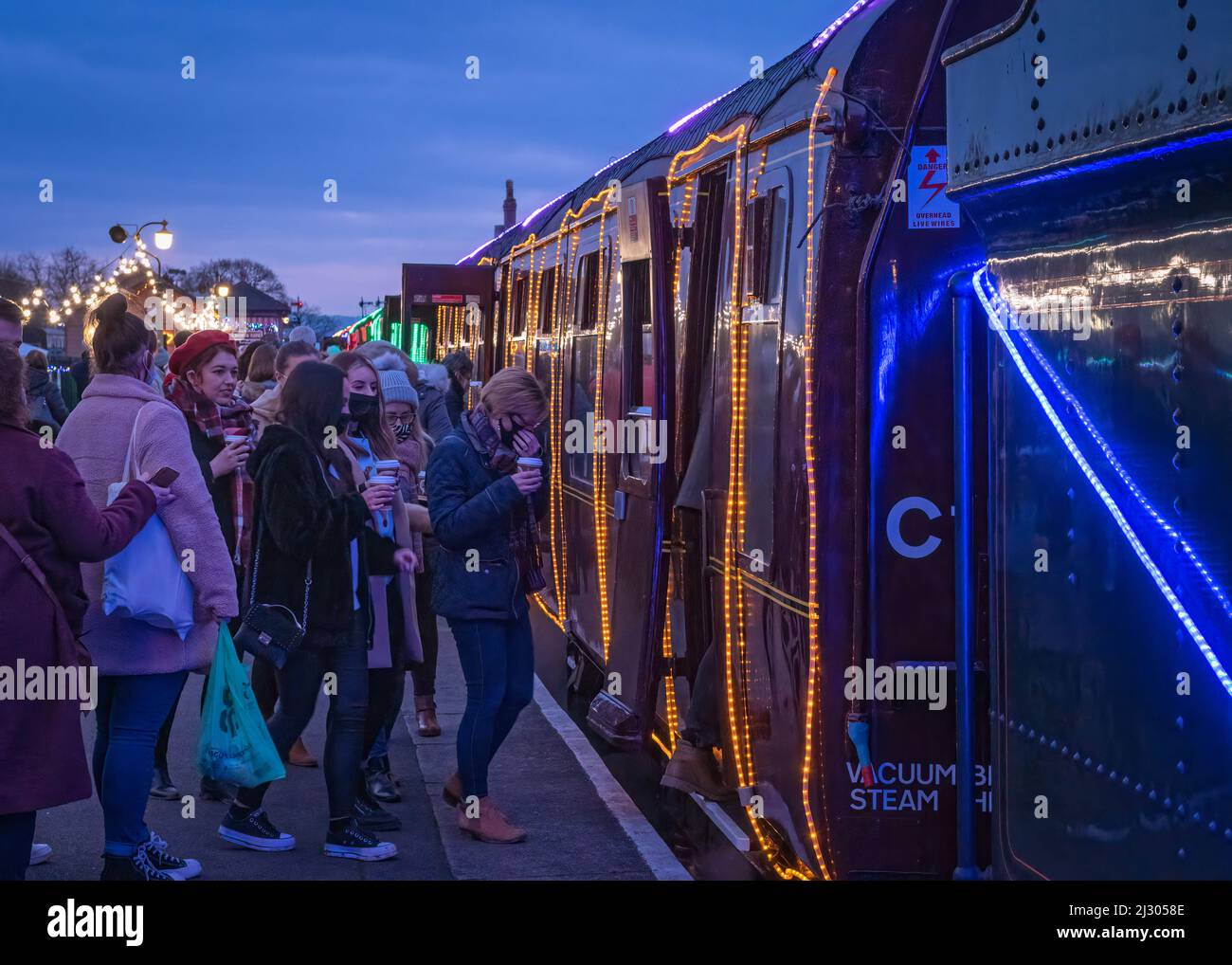 Passengers boarding the illuminated 'Winter Lights' Christmas special