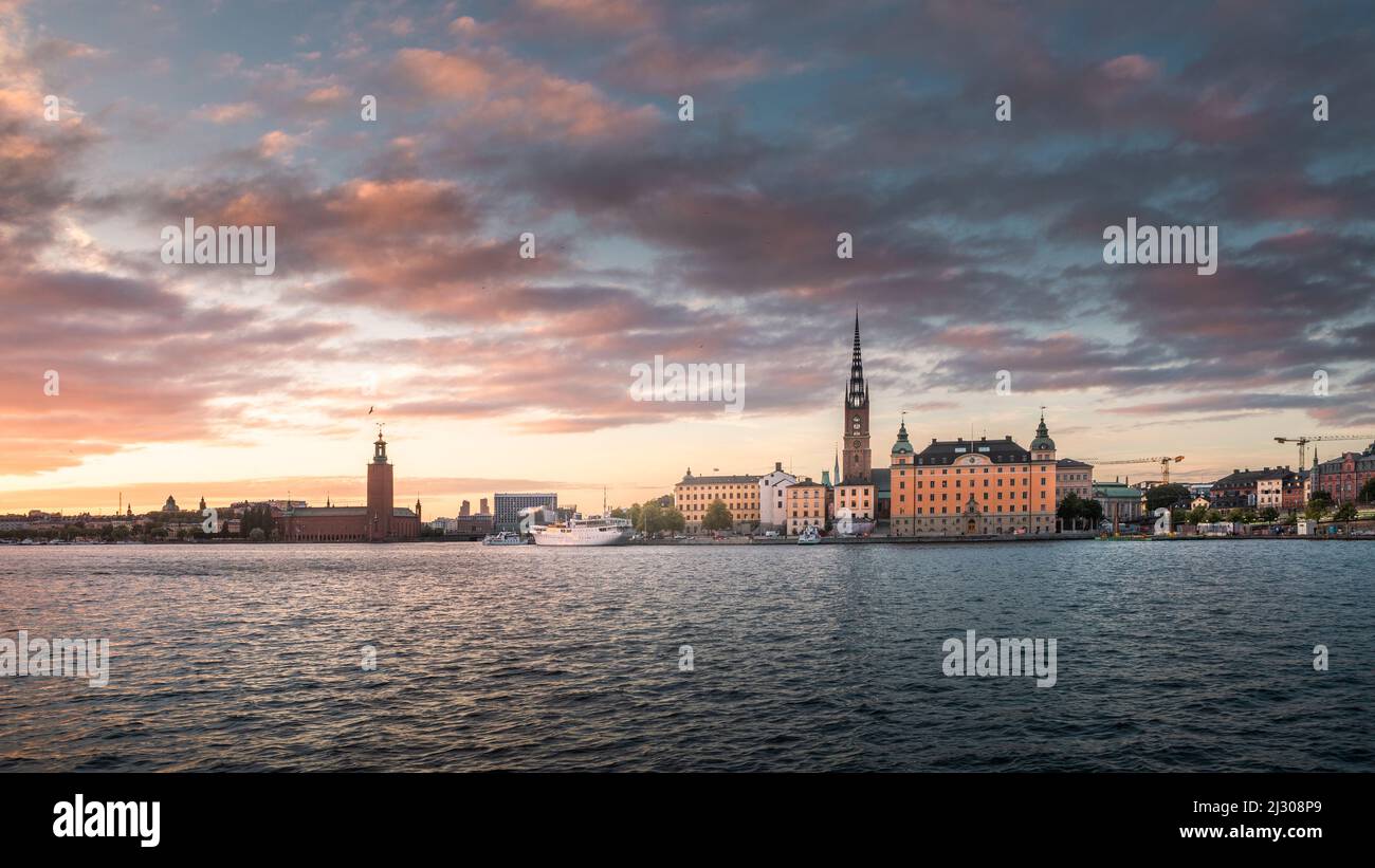 Stockholm skyline at sunset with Riddarholmskyrkan church on Gamla Stan old town island and Stadshus in Sweden Stock Photo