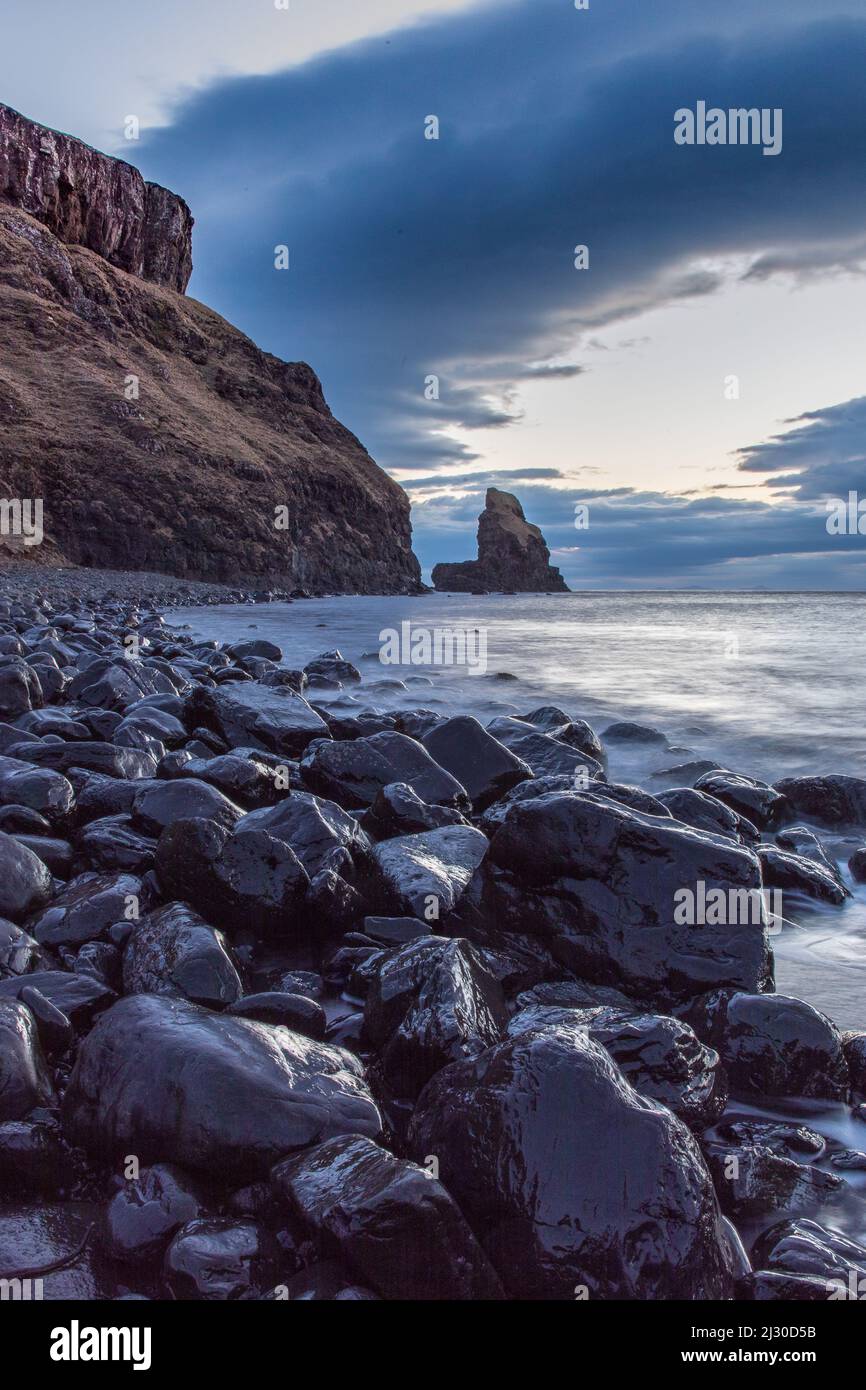 Dusk, shiny stones at low tide on Talisker Bay beach, Isle of Skye, Scotland, UK Stock Photo
