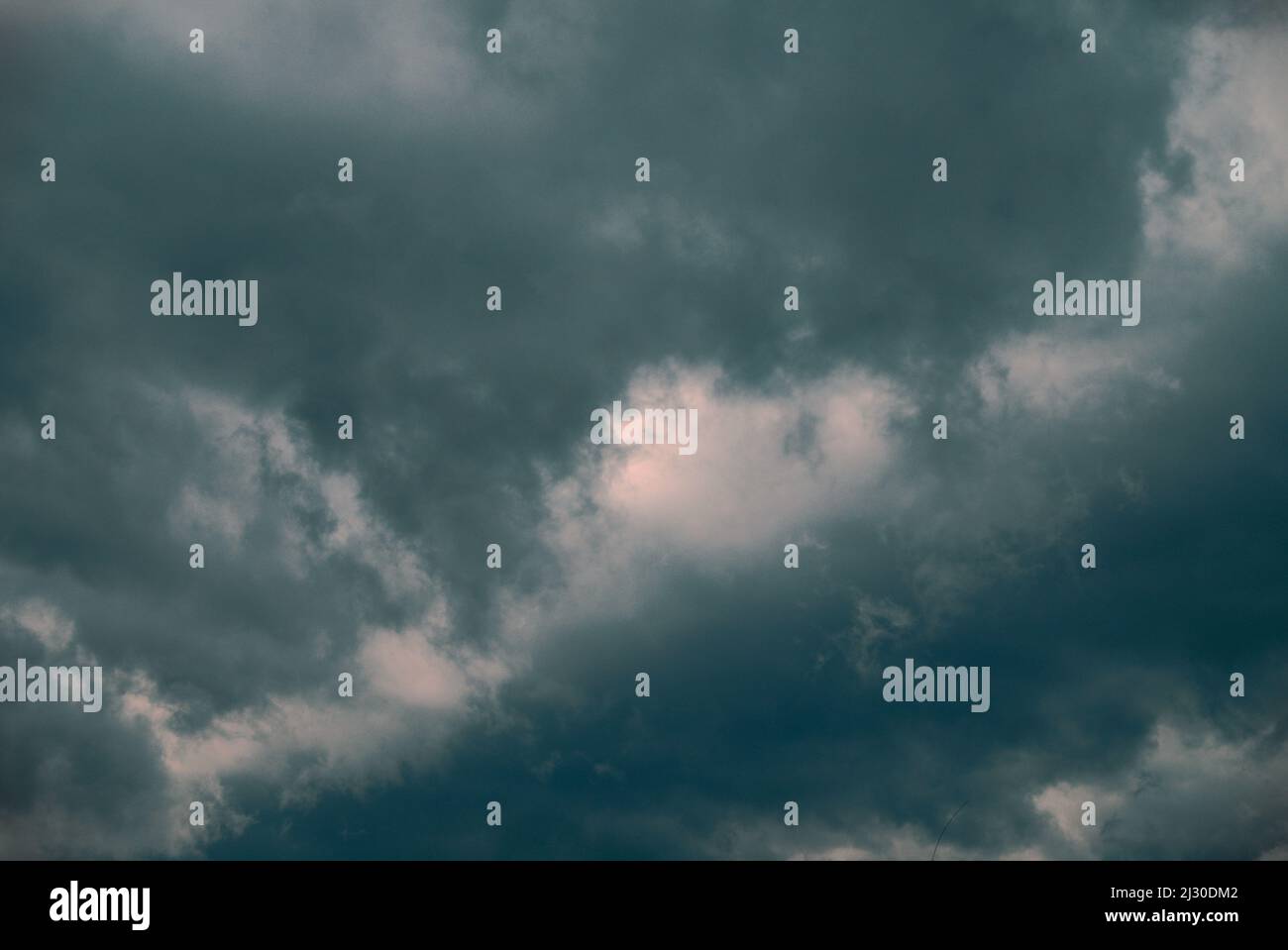 A low angle shot of a gray cloudy sky before the storm during daytime ...