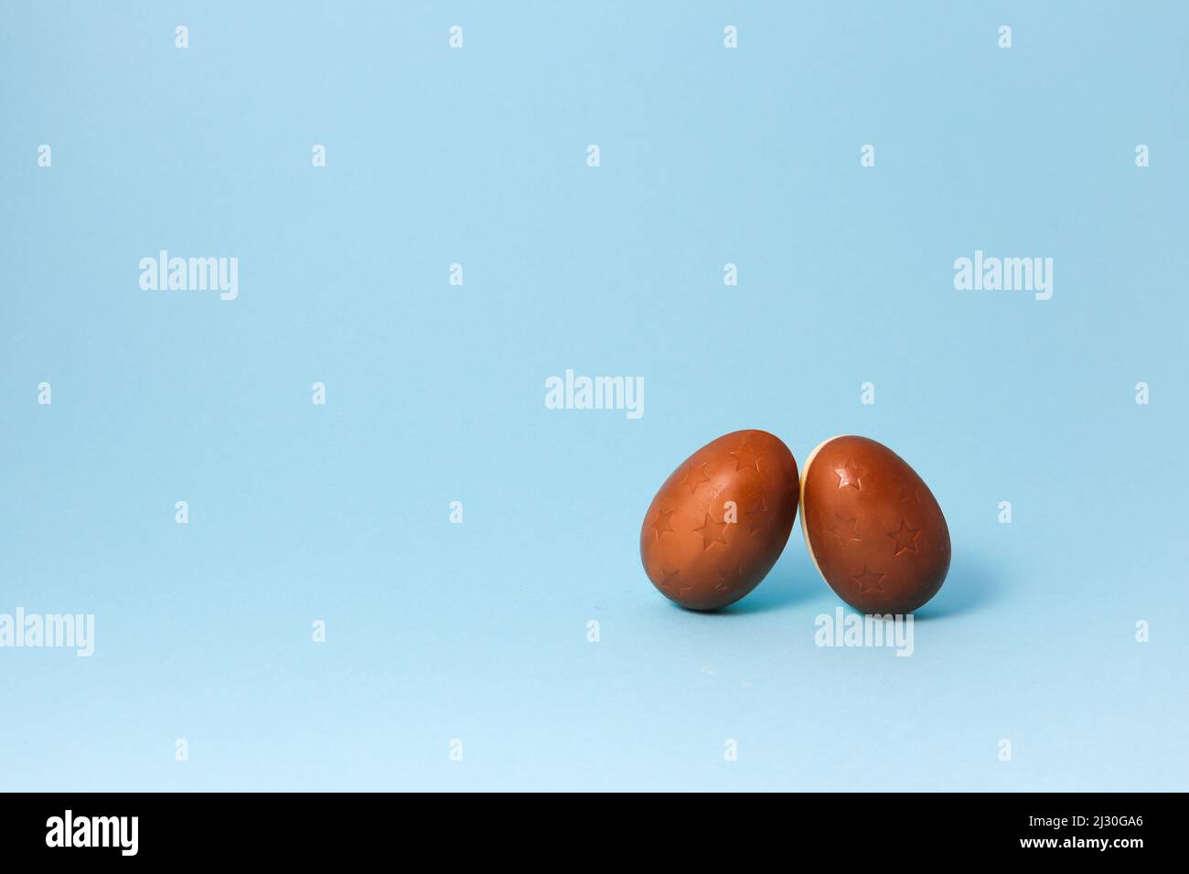 Two Chocolate Easter eggs on blue background. Close up Easter Concept Stock Photo