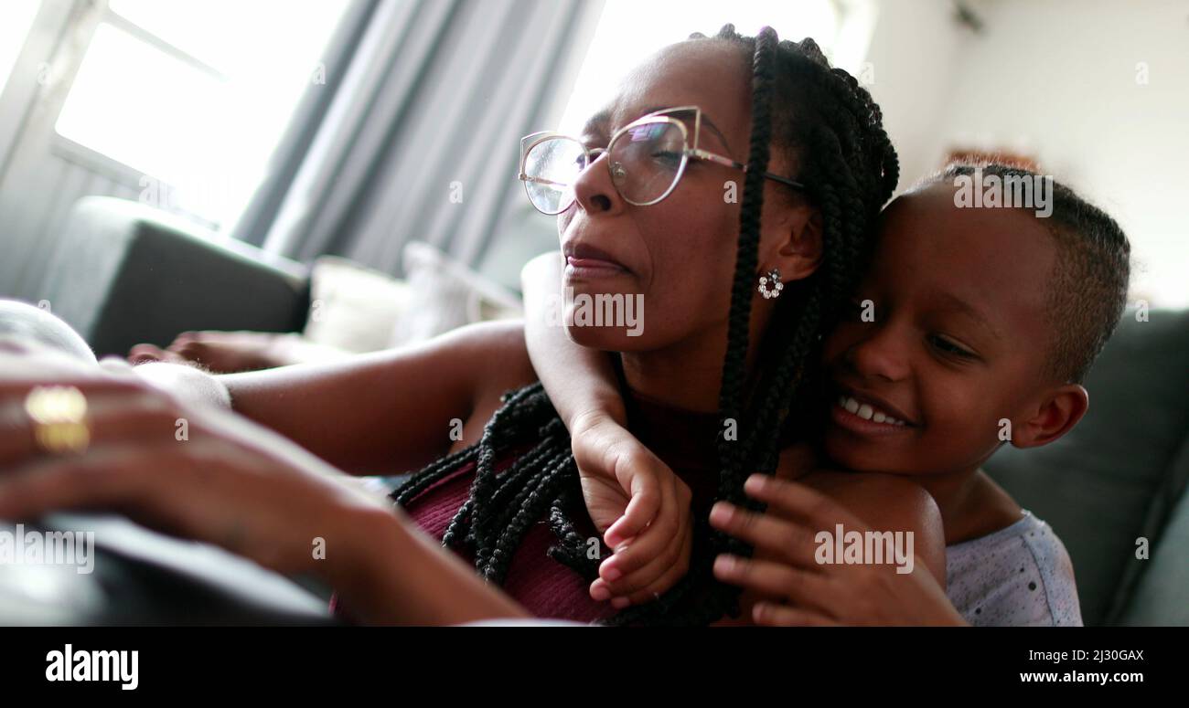 Mother multi-tasking working from hom with child, parent trying to ...