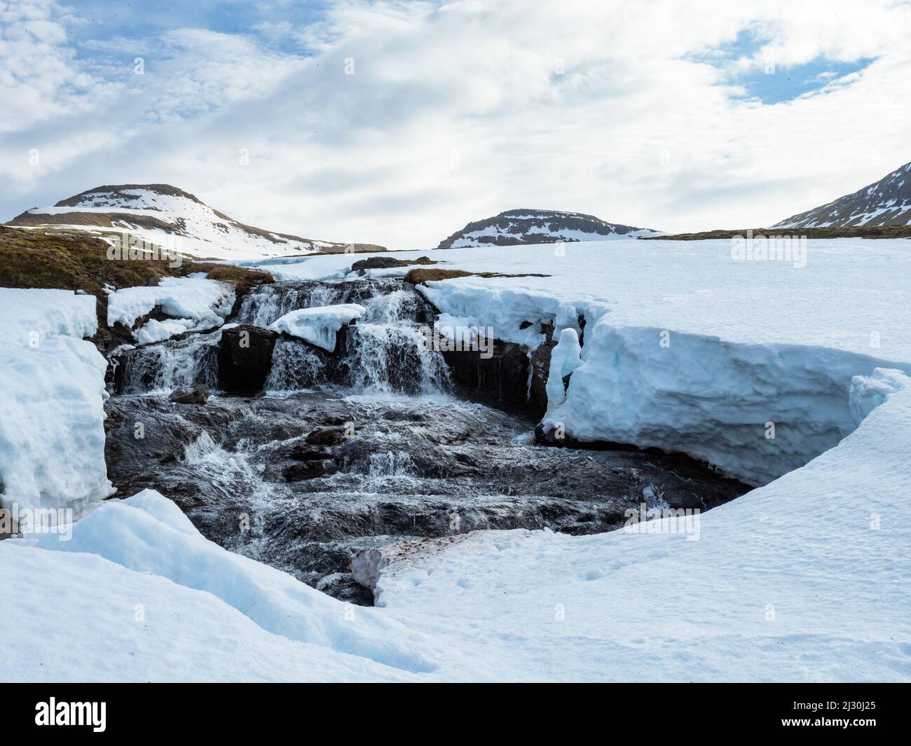 Melting snow, Hornstrandir Nature Reserve, Hornvik Bay, Iceland, Europe Stock Photo