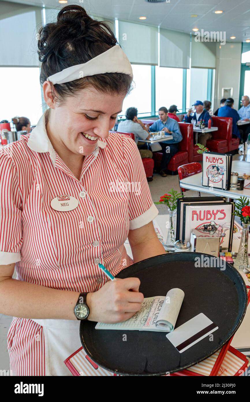 Huntington Beach California,Municipal Pier,Ruby's Diner,waitress server employee interior inside woman female working job,worker taking writing order Stock Photo