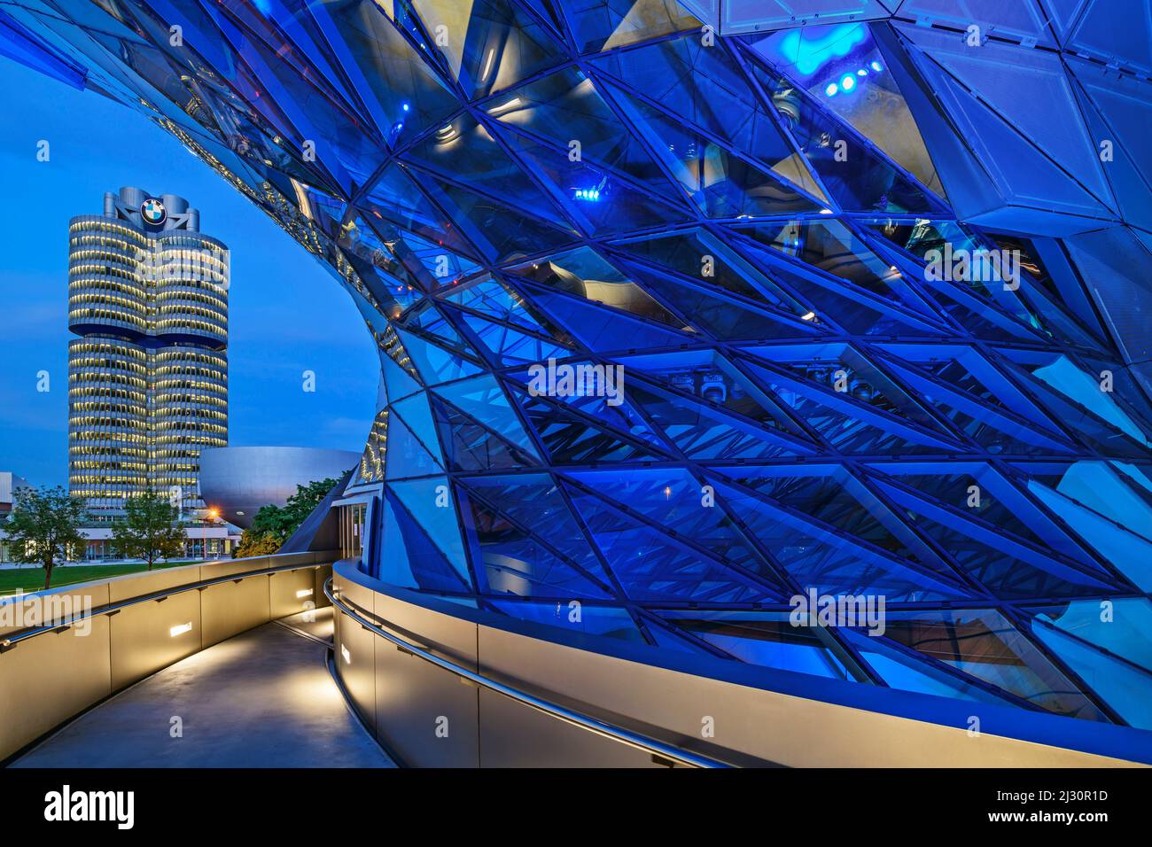 Blue illuminated BMW Welt building with BMW four-cylinder and BMW ...