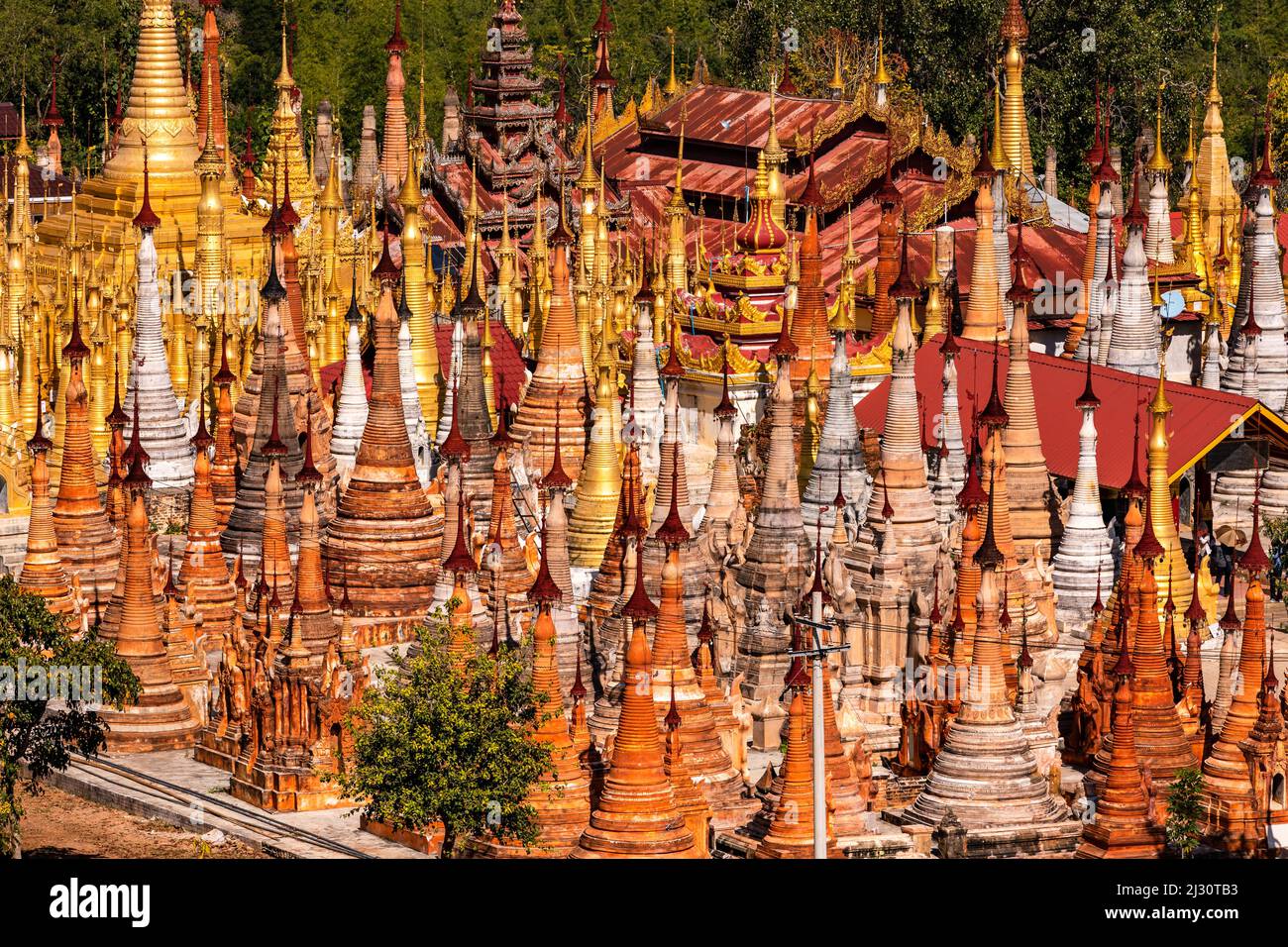 The pagoda forest of In-Dein on the Burmese Inle Lake consists of many ring-shaped tapering stupas Htis as a closure Stock Photo