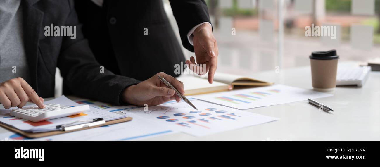 Teamwork process, Business adviser analyzing financial figures denoting the progress in the work of the company Stock Photo