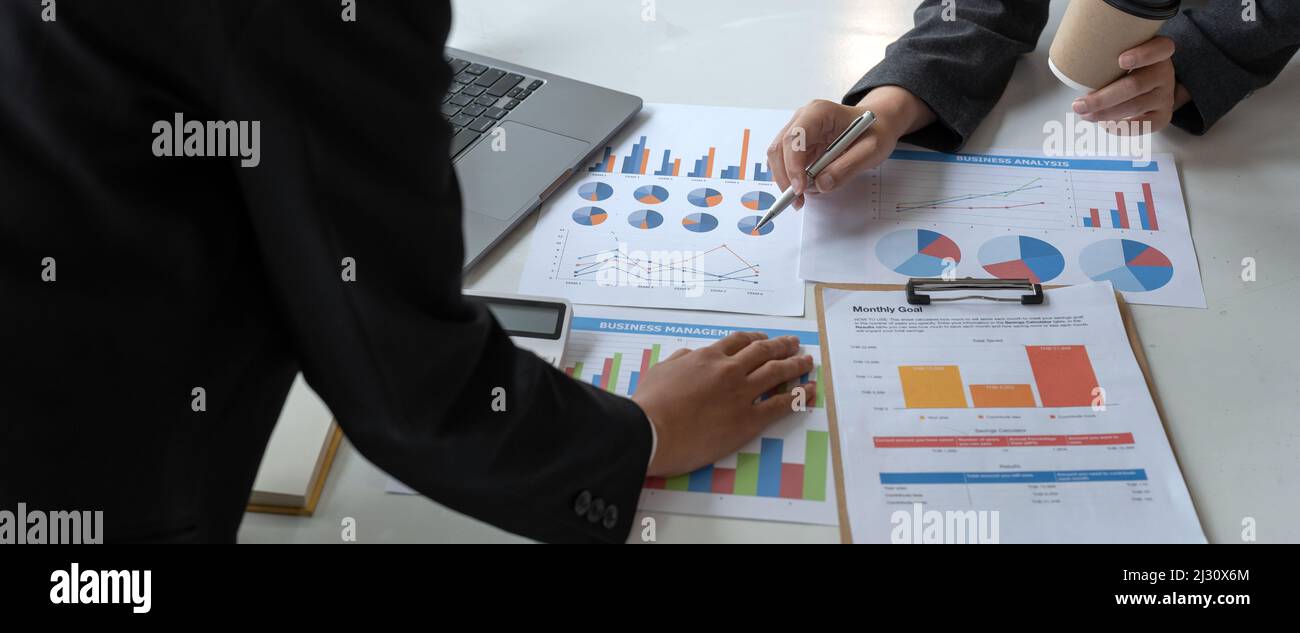 Asian business adviser meeting to analyze and discuss the situation on the financial report in the meeting room.Investment Consultant, Financial Stock Photo
