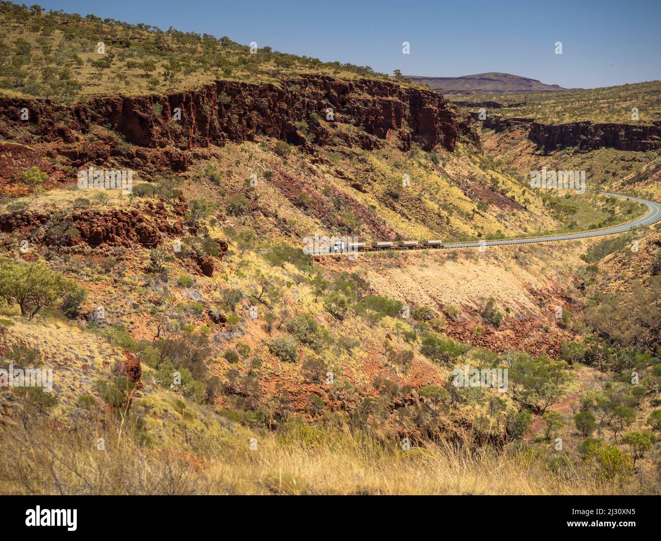 Road train climbing  through Munjina East Gorge on the Great Northern Highway, Juna Downs, Pilbara, Western Australia Stock Photo