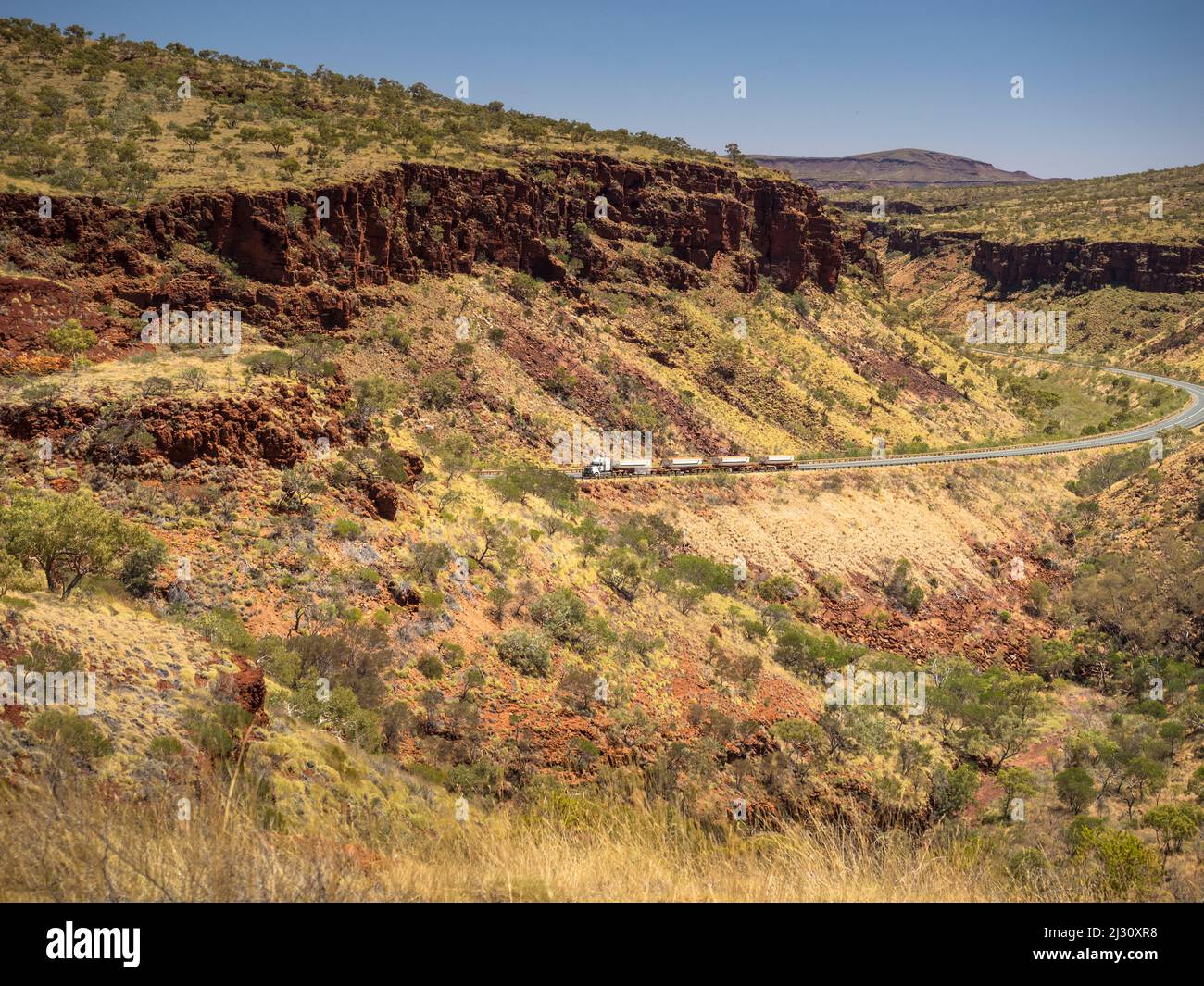 Road train climbing  through Munjina East Gorge on the Great Northern Highway, Juna Downs, Pilbara, Western Australia Stock Photo