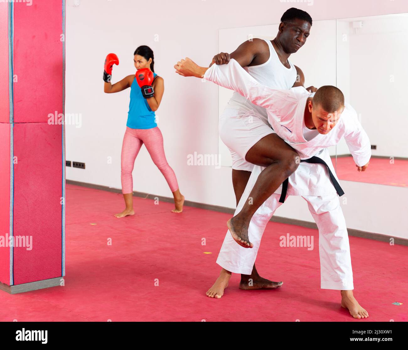 Self defense training in gym. Men in sparring train to do power grabs