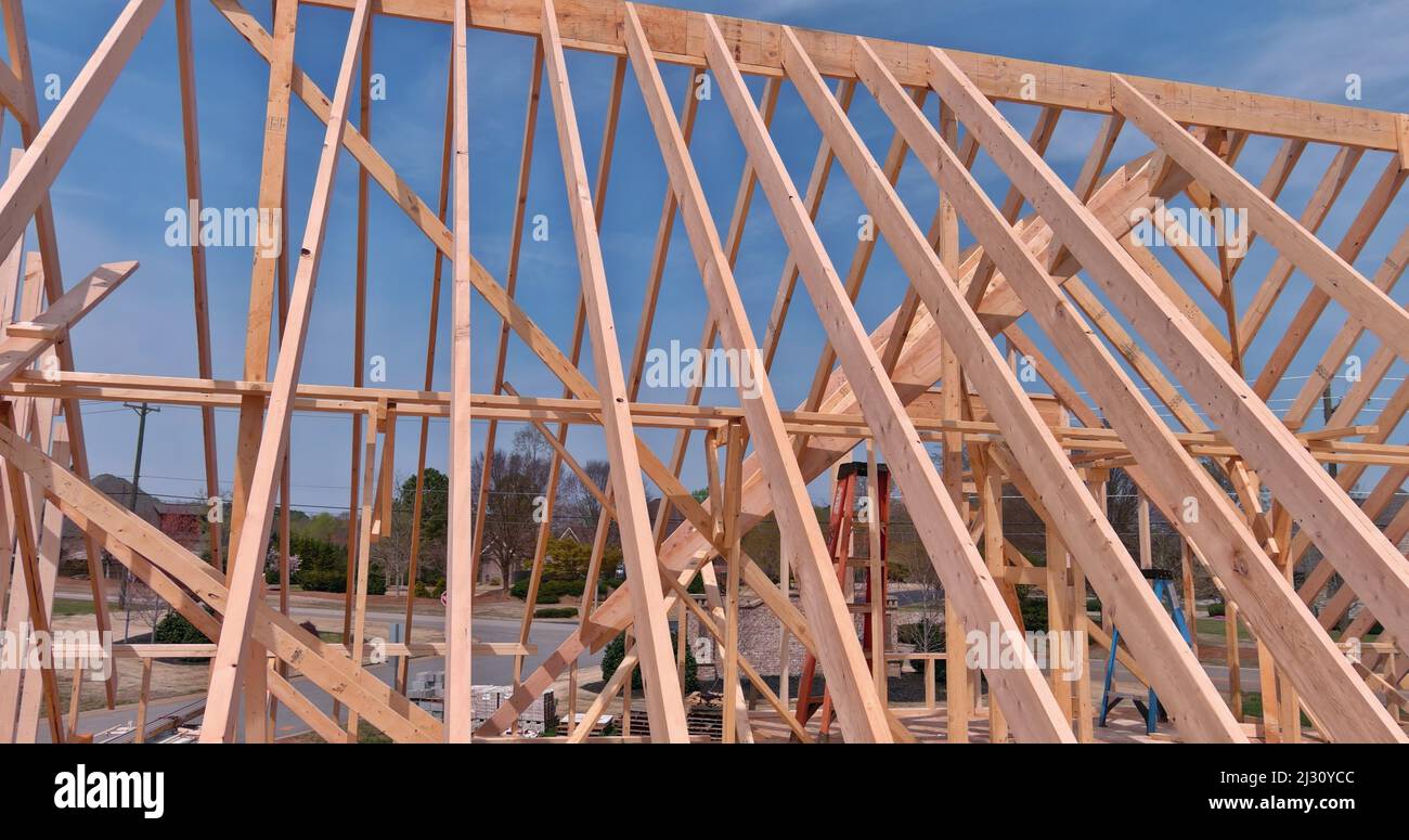 Roofing installing house roof beams for roofing under construction