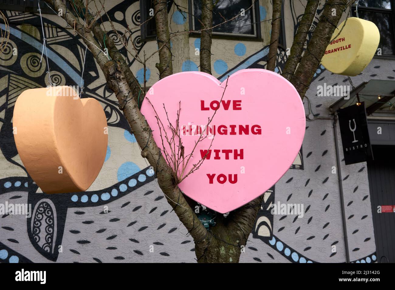 Love-themed heart installation, hearts  hanging from trees in Vancouver, British Columbia, Canada Stock Photo