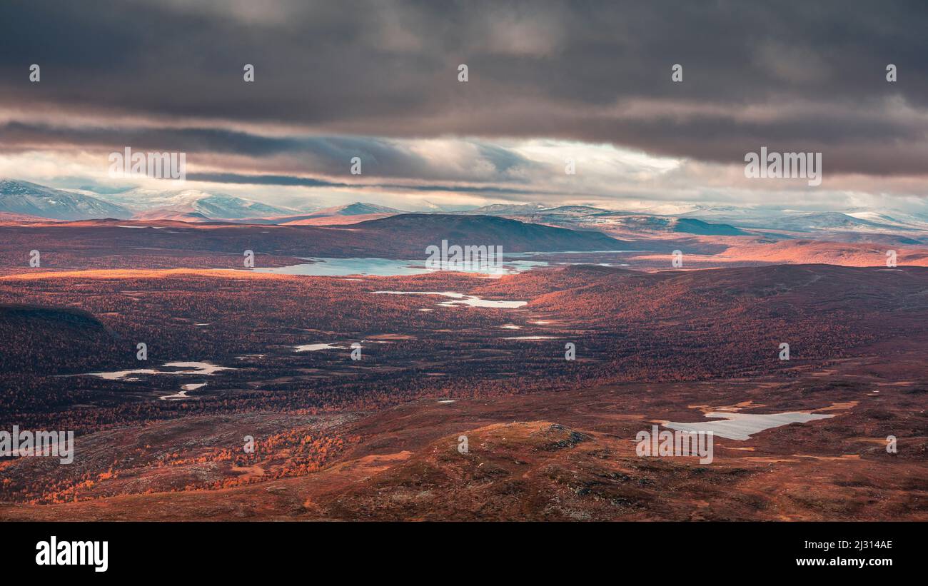 Mountain landscape with lakes and snow-covered peaks in Pieljekaise National Park in autumn in Lapland in Sweden Stock Photo