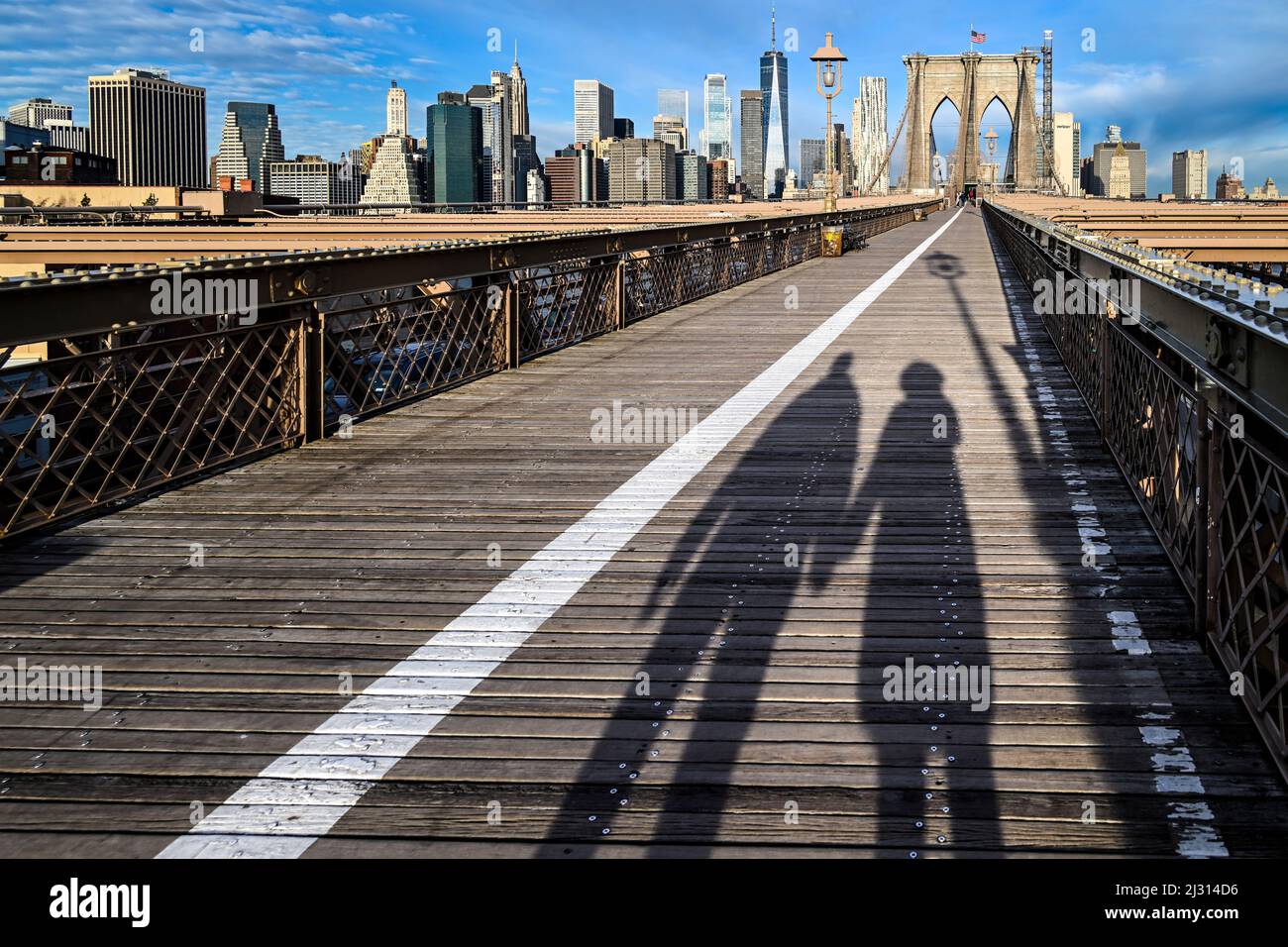 the shadows of two friends or lovers holding hands walking across the ...