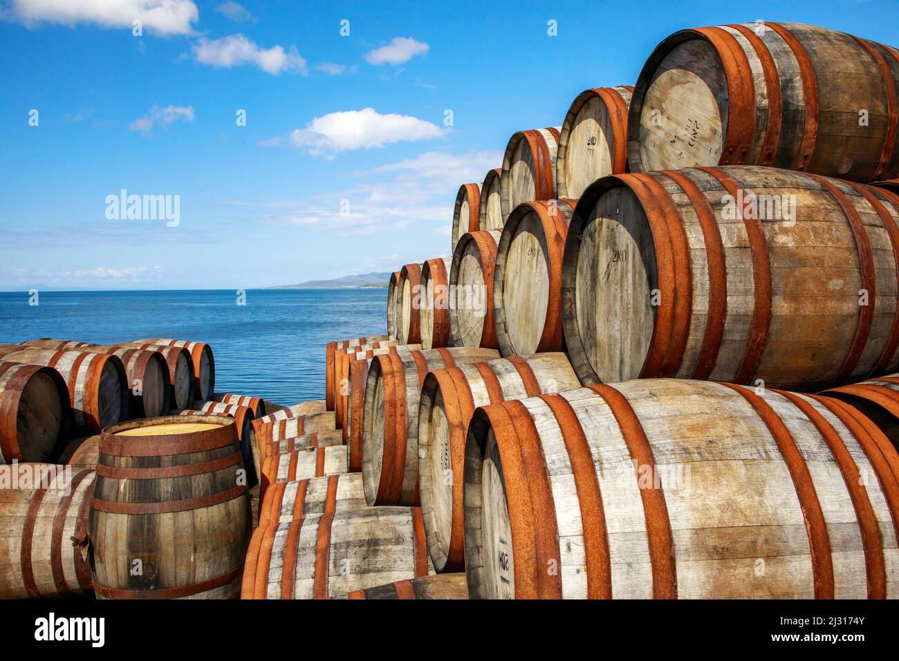 Quayside, empty stacked whiskey barrels by the sea, Bunnahabhain