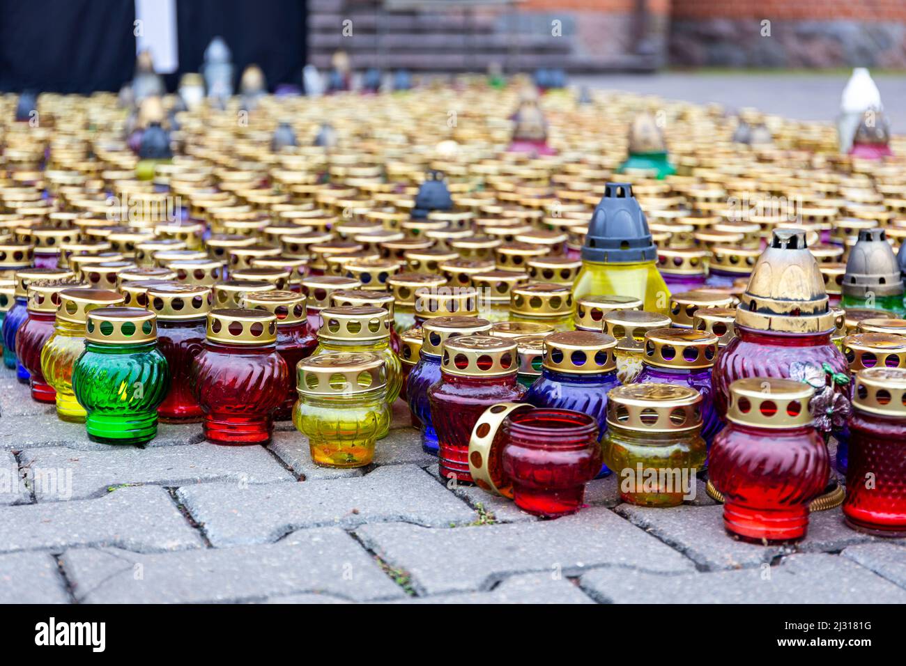 Many colorful grave candles (lanterns), traditional decoration of tombs on All Saints Day (1 November). Stock Photo