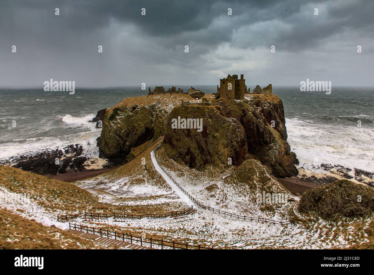 Gloomy black clouds over Dunnottar Castle in winter, storm, North Sea, ruin, Aberdeenshire, Scotland, UK Stock Photo