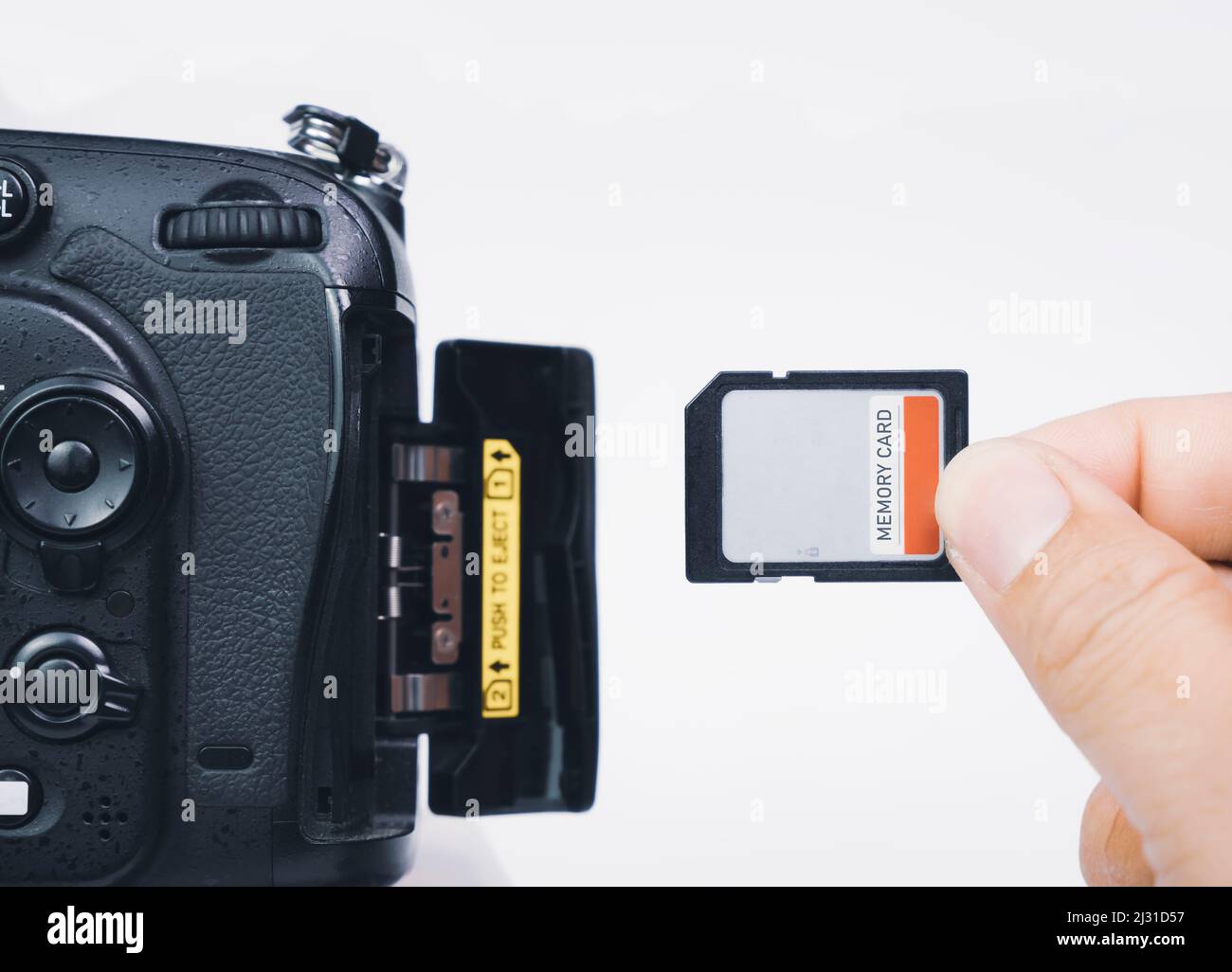 Photographer hand insert memory SD card to memory slot of the digital ...