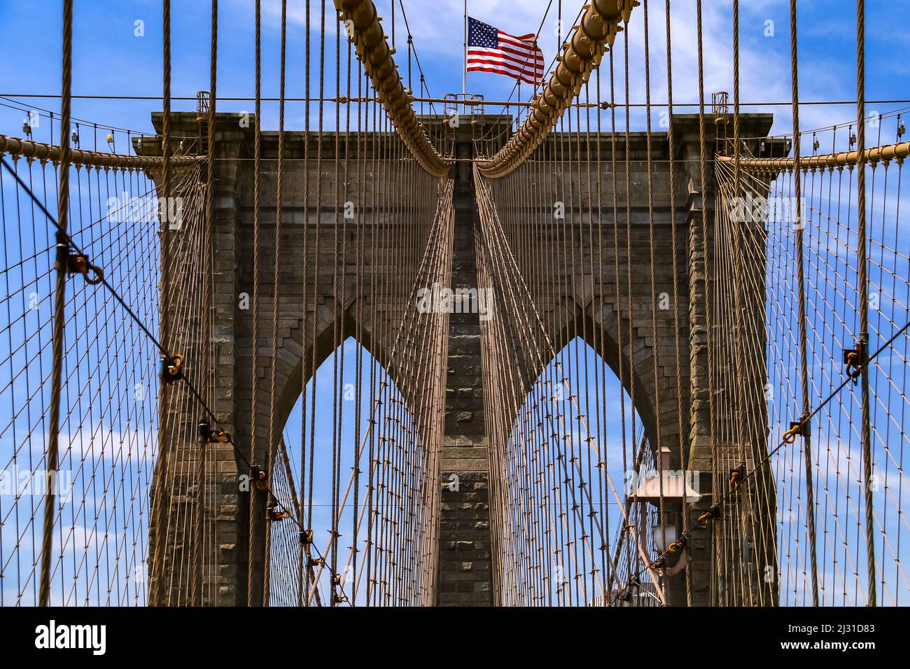 The ropes of the bridge tower of the Brooklyn Bridge in New York are attached symmetrically Stock Photo