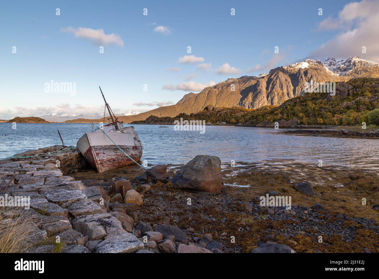 Old derelict fishing boat at Fiskebol quay wall, Austvagoya, Lofoten, Norway Stock Photo