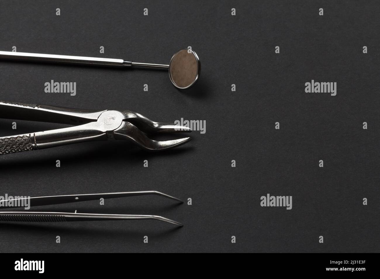 Tweezers, a stainless steel dental pliers and a mouth mirror on the