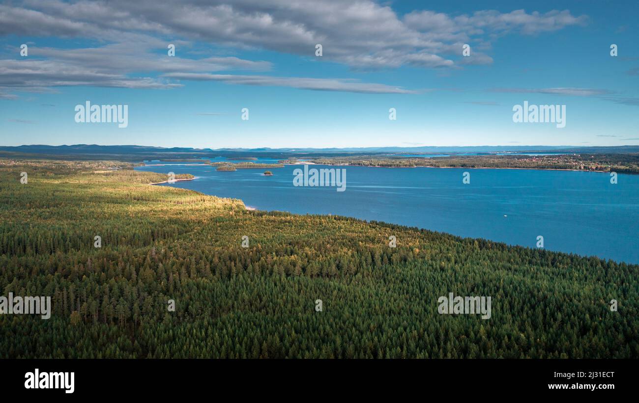 Forest and lakeshore at Lake Siljan from above with blue sky in Dalarna, Sweden Stock Photo
