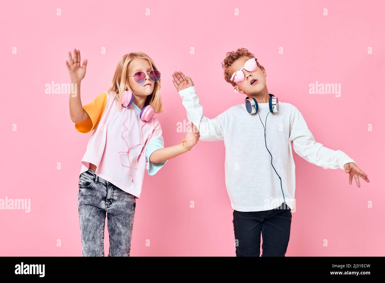 cute smiling kids wearing headphones posing casual kids fashion Stock