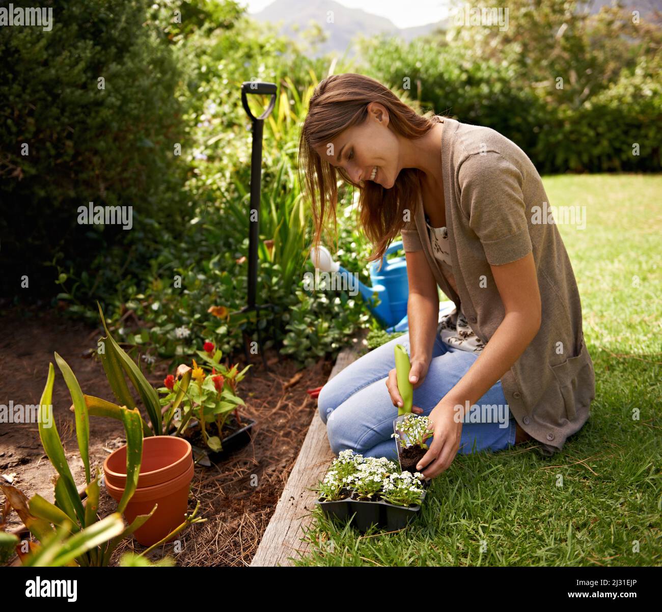 Staying in touch with her inner gardner. A young woman gardening. Stock Photo