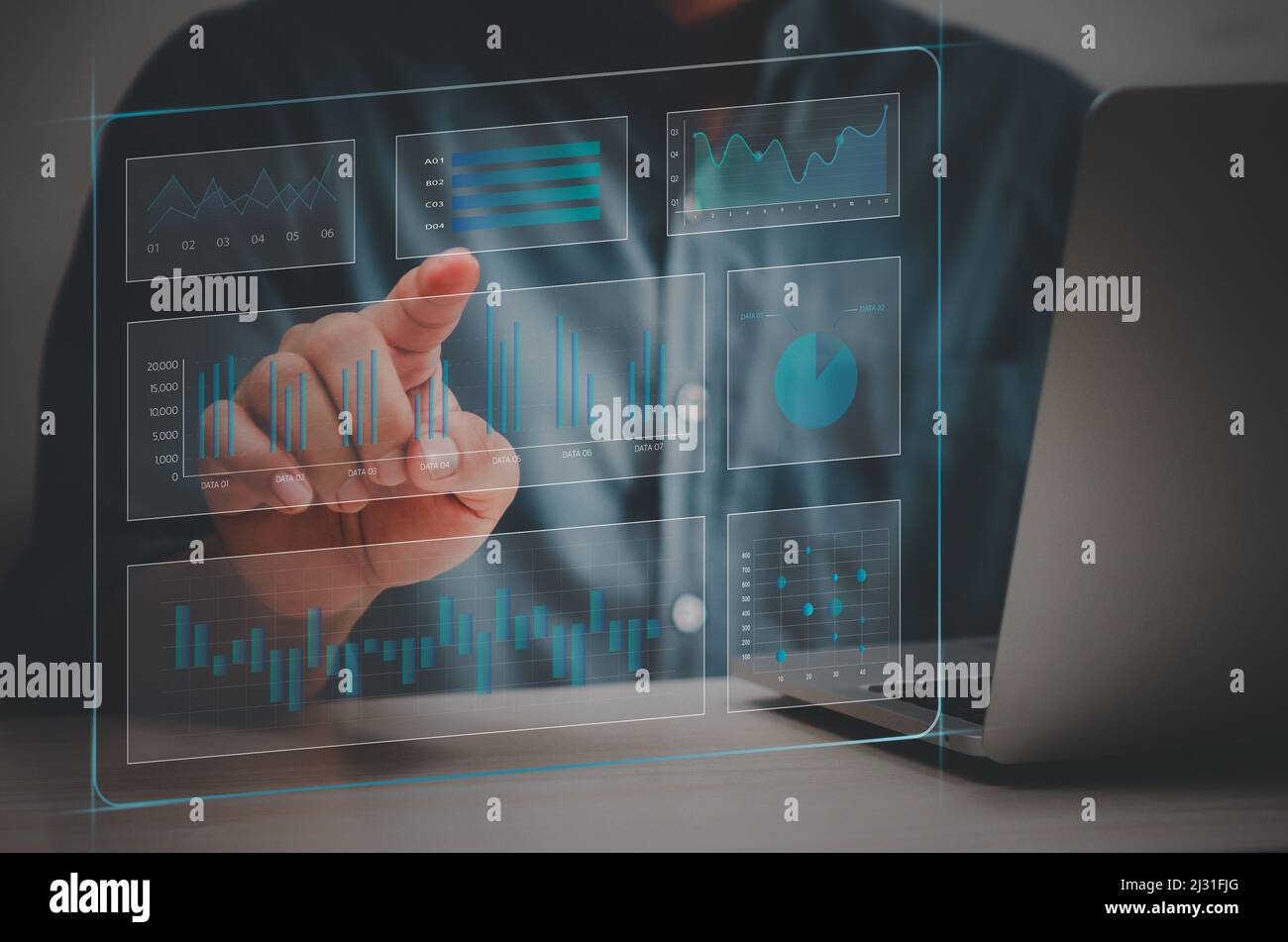 man hand using laptop to working technology.Hand toucing virtual screen graph and chart data analysis and big data business concept. Stock Photo