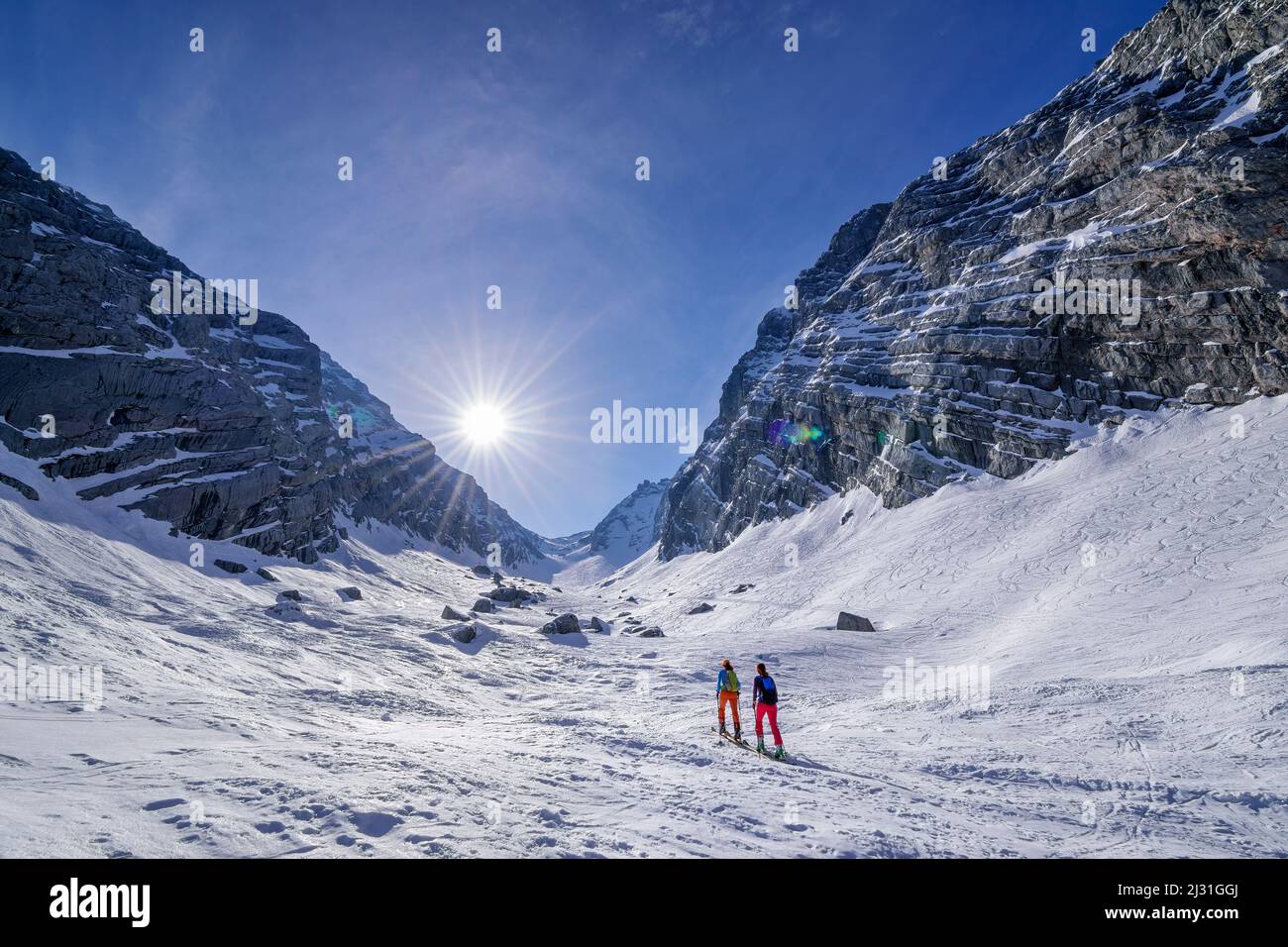 Two people on a ski tour ascend through Weites Kar, Ofental, Berchtesgaden Alps, Berchtesgaden National Park, Upper Bavaria, Bavaria, Germany Stock Photo