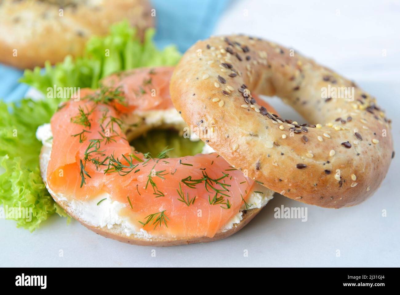 Fresh multigrain bagel bun with cream cheese, salmon slices, dill green