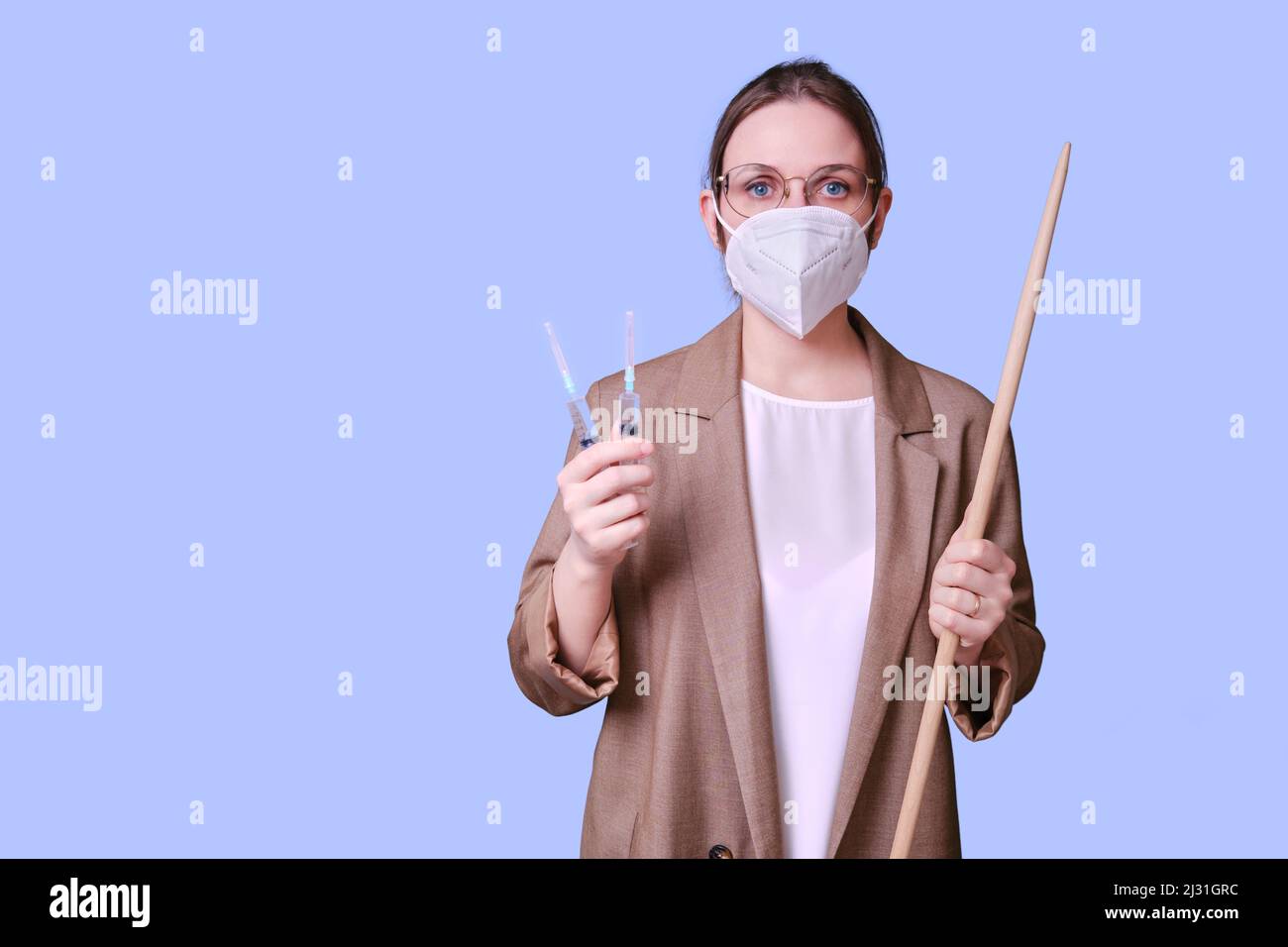 Woman teacher in medical face mask holds syringes for vaccination on ...