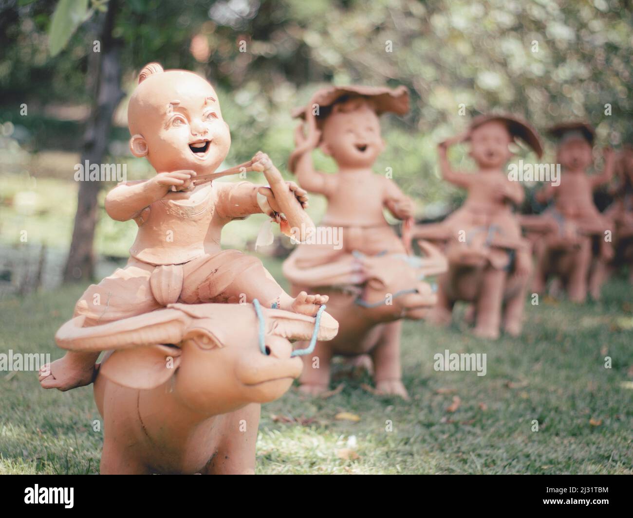 Statues of children playing in the garden in thailand. Stock Photo