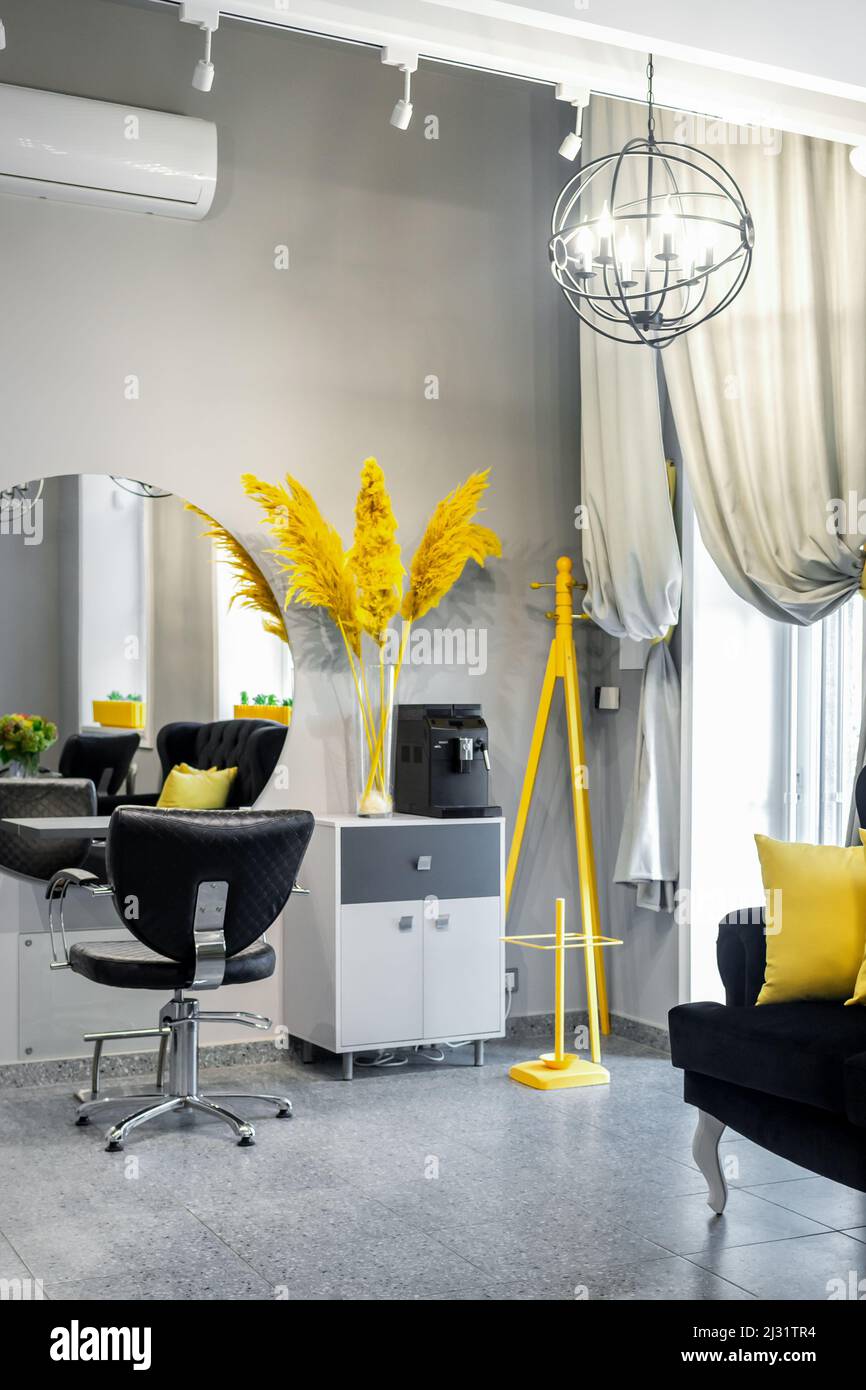 Modern small bright hair and beauty salon in black and yellow colors with gray walls and floor and black sofa with yellow cushions Stock Photo - Alamy Modern small bright hair and beauty salon in black and yellow colors with gray walls and floor and black sofa with yellow cushions Stock Photo - Alamy