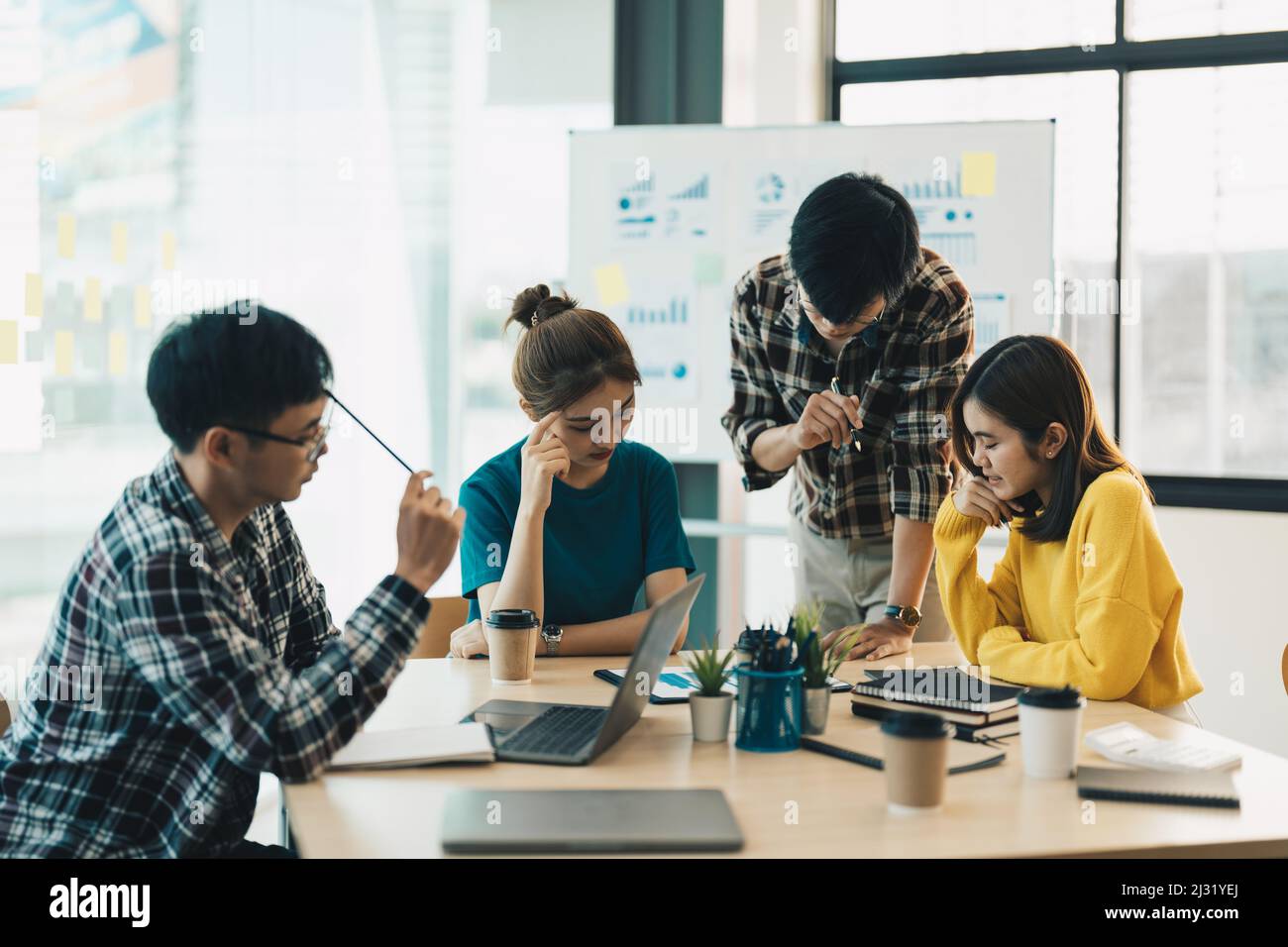 Group of young asian business people meeting to discussing business ideas together colleagues brainstorm negotiate at briefing in boardroom Stock Photo