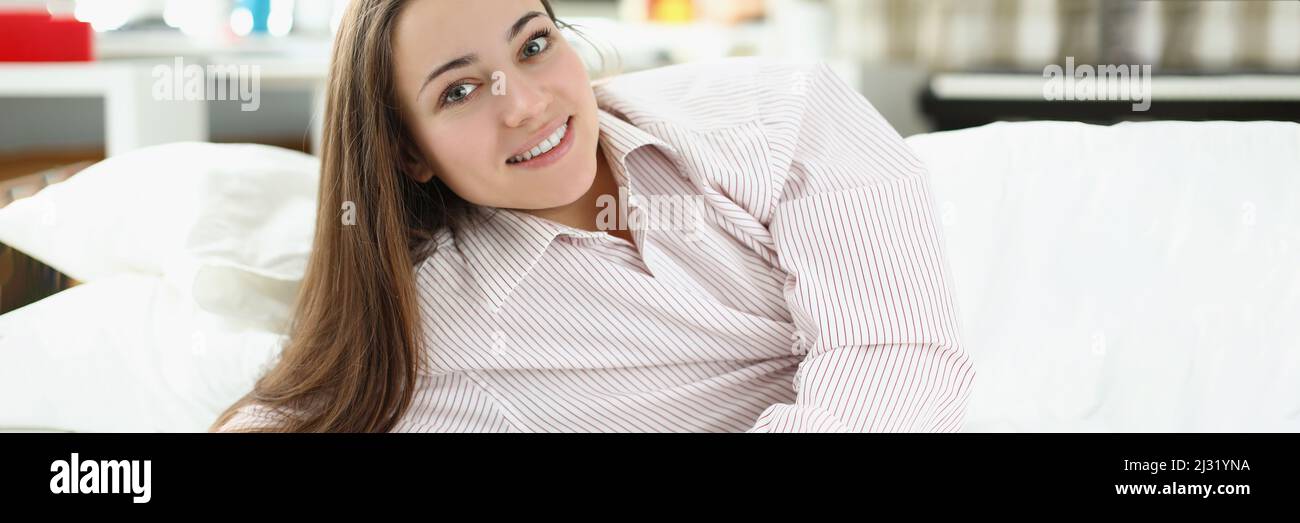 Brunette girl laying in bed Stock Photo